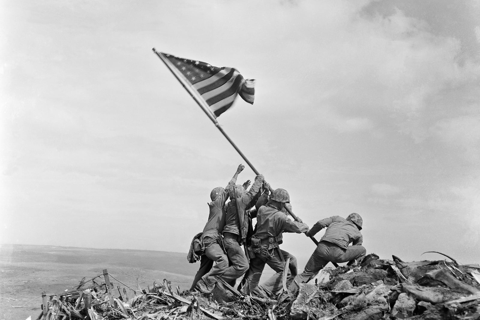 FILE - U.S. Marines of the 28th Regiment, 5th Division, raise a U.S. flag atop Mount Suribachi, Iwo Jima, Japan, Feb. 23, 1945. (AP Photo/Joe Rosenthal, File)