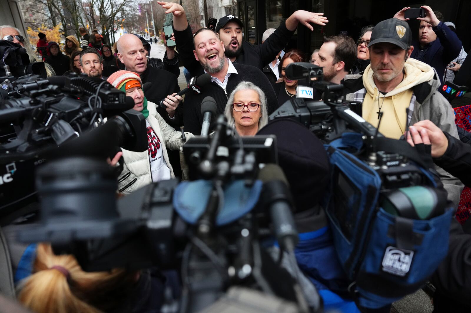 Pat King, top center, a prominent figure in Canada’s trucker protests against COVID-19 restrictions in 2022, is surrounded by supporters and media as he leaves court in Ottawa, Ontario, Friday, Nov. 22, 2024. (Sean Kilpatrick/The Canadian Press via AP)