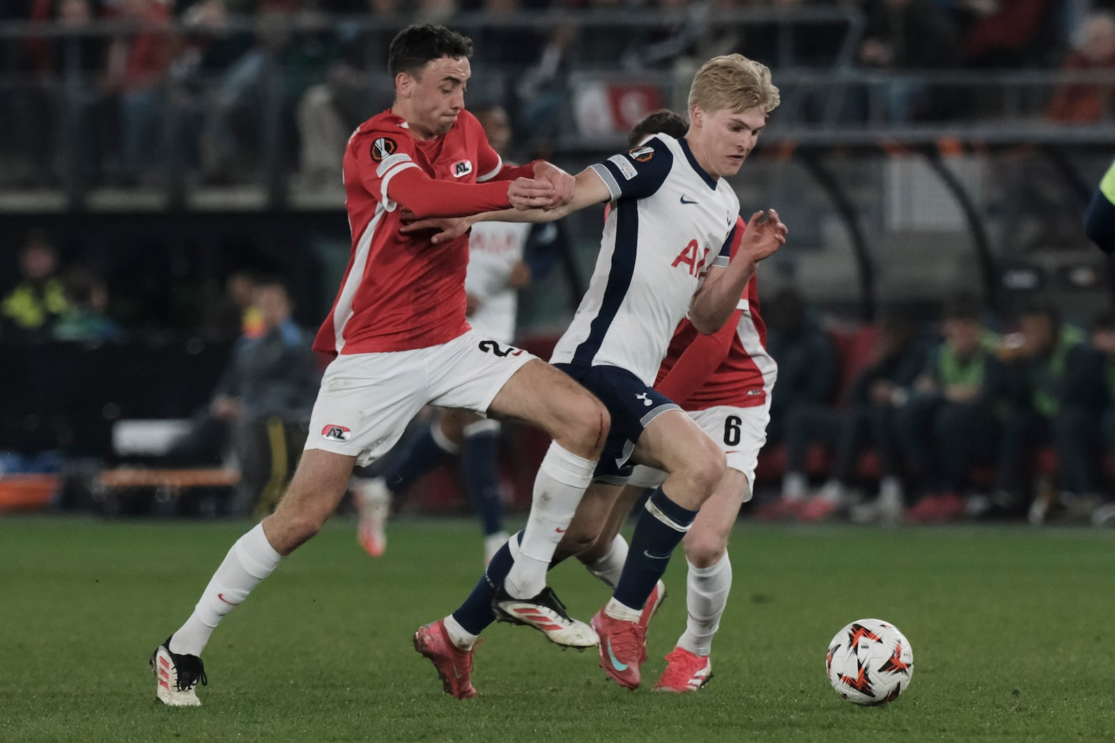 Tottenham's Lucas Bergvall, right, challenges for the ball with AZ Alkmaar's Zico Buurmeester during the Europa League round of 16 first leg match between AZ and Tottenham at AFAS Stadium, in Alkmaar, in Alkmaar, Netherlands, Thursday, March 6, 2025. (AP Photo/Patrick Post)