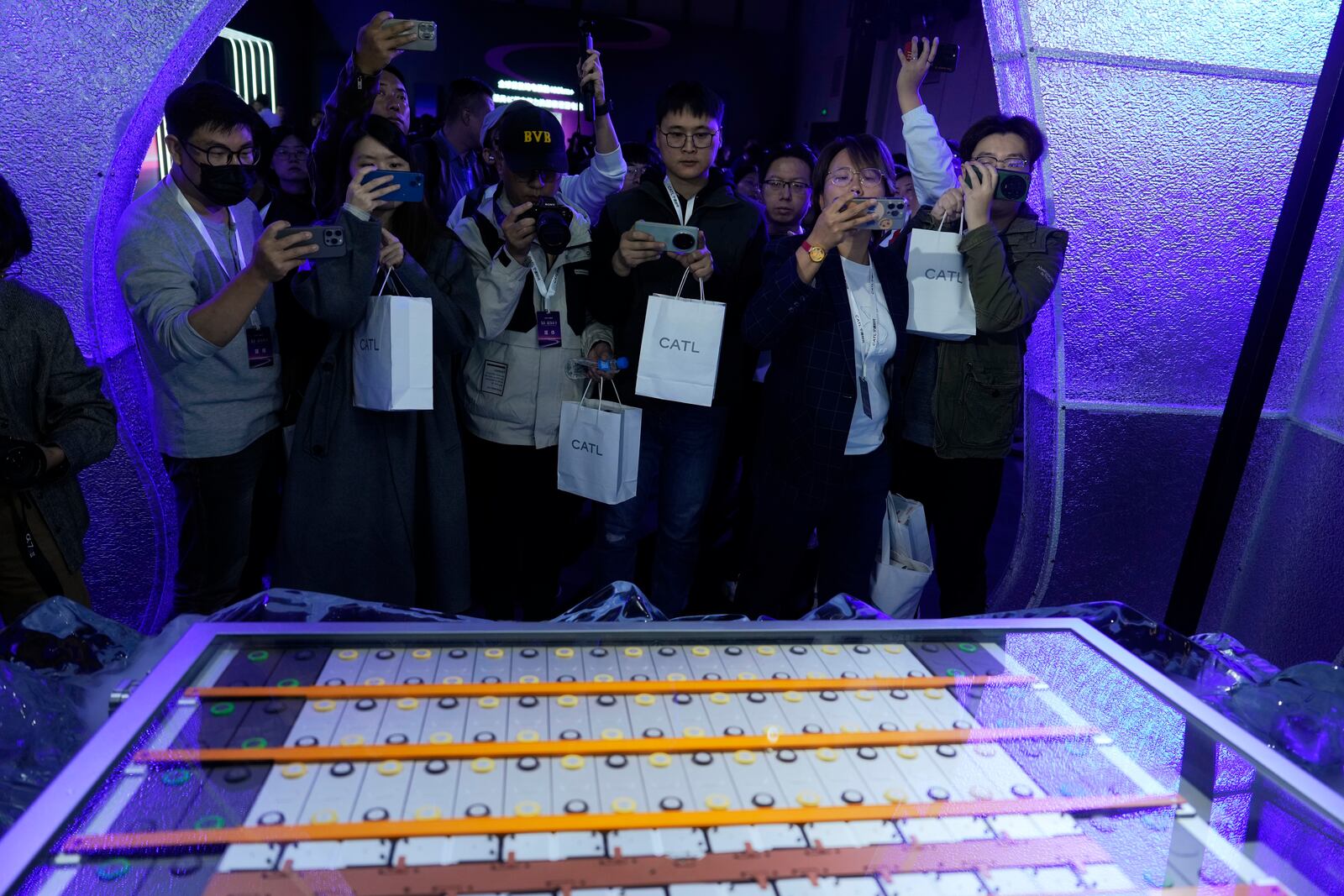 FILE -FILE - Members of the media take photos of the latest Freevoy Super Hybrid Battery from Chinese battery manufacturer Contemporary Amperex Technology (CATL) during a launch event in Beijing, Oct. 24, 2024. (AP Photo/Ng Han Guan, File)