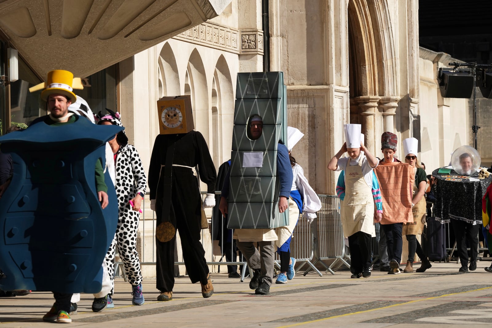 Competitors parade in costumes during a traditional pancake race by livery companies at the Guildhall in London, Tuesday, March 4, 2025.(AP Photo/Frank Augstein)