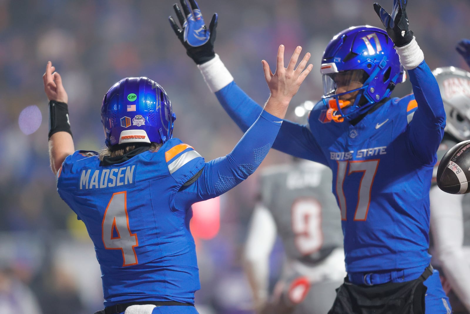 Boise State quarterback Maddux Madsen (4) celebrates after a touchdown run against UNLV with wide receiver Prince Strachan (17) late in the first half of the Mountain West Championship NCAA college football game Friday, Dec. 6, 2024, in Boise, Idaho. (AP Photo/Steve Conner)