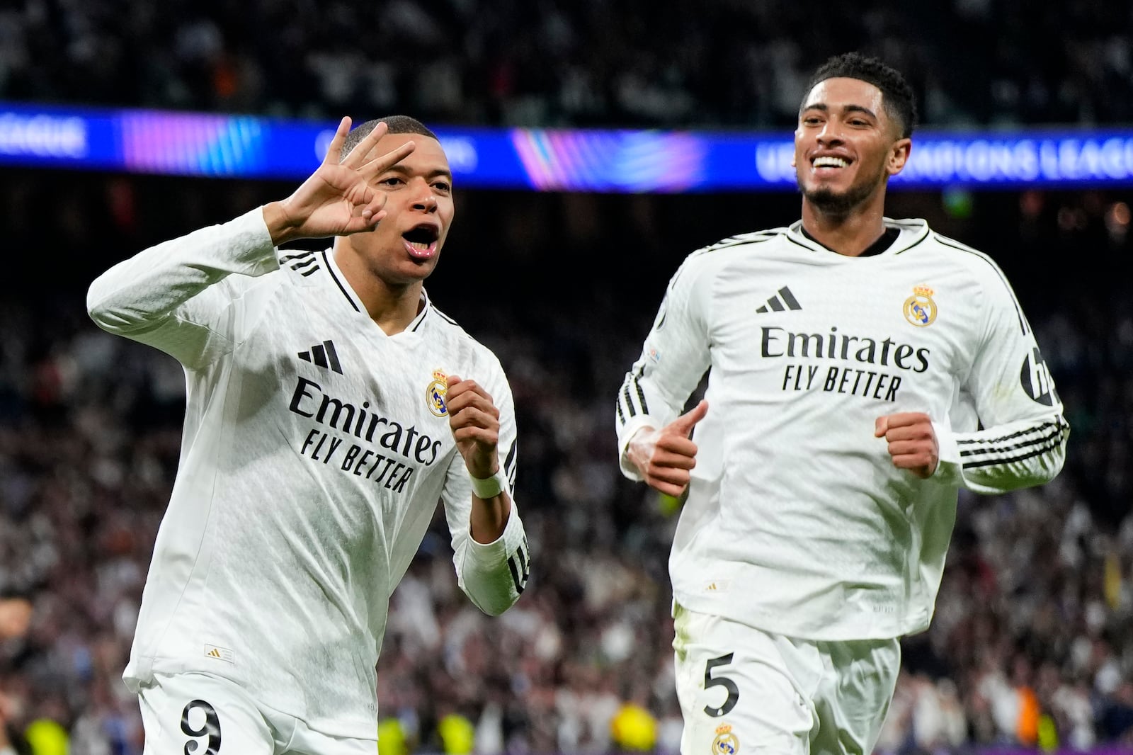 Real Madrid's Kylian Mbappe celebrates with Real Madrid's Jude Bellingham, right, after scoring his sides third goal during the Champions League playoff second leg soccer match between Real Madrid and Manchester City at the Santiago Bernabeu Stadium in Madrid, Spain, Wednesday, Feb. 19, 2025. (AP Photo/Manu Fernandez)