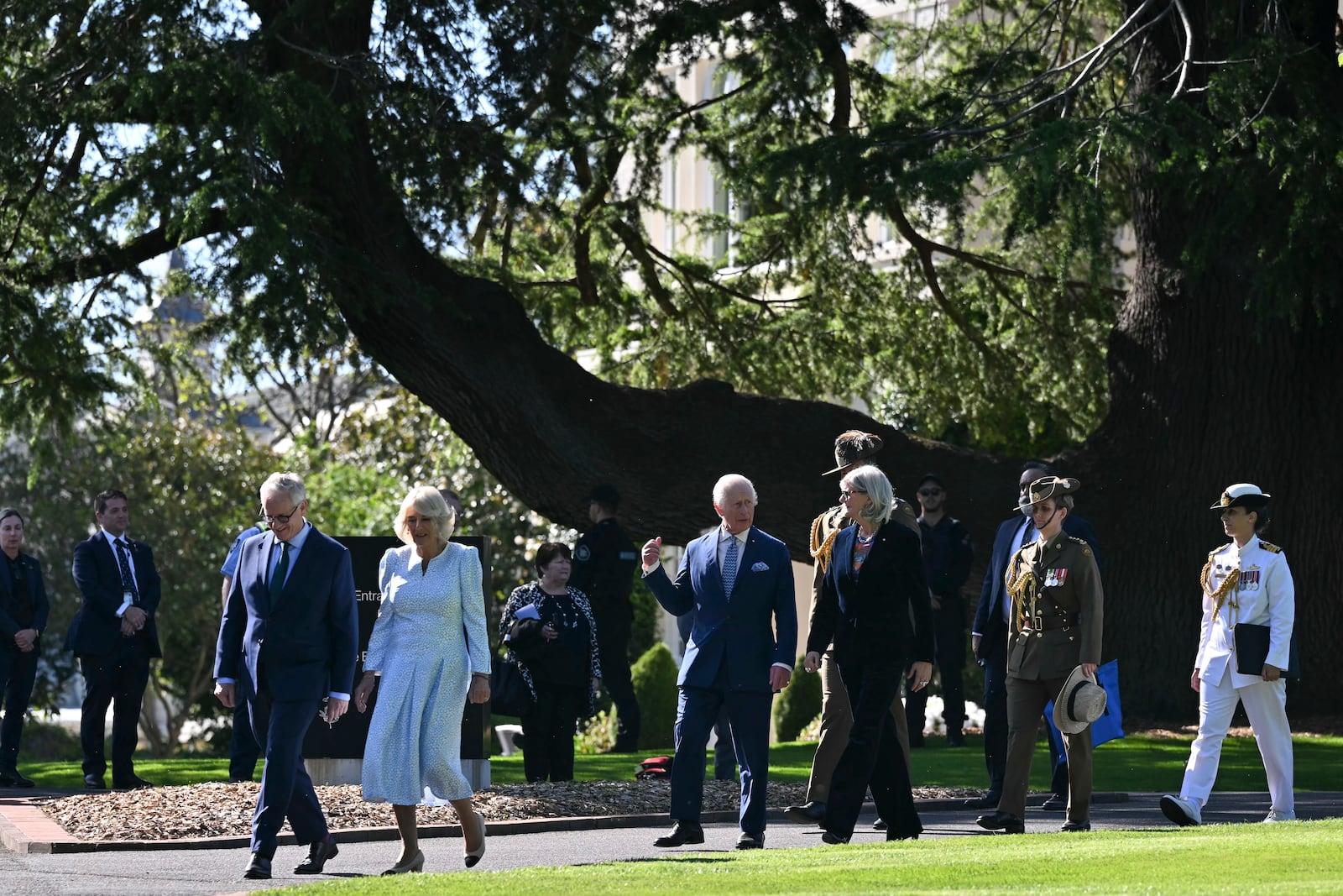 Britain's King Charles III, center, Queen Camilla, 2nd left, and Australia's Governor-General Sam Mostyn walk to take part in a tree planting ceremony at Government House in Canberra, Australia, Monday, Oct. 21, 2024. (Saeed Khan/Pool Photo via AP)