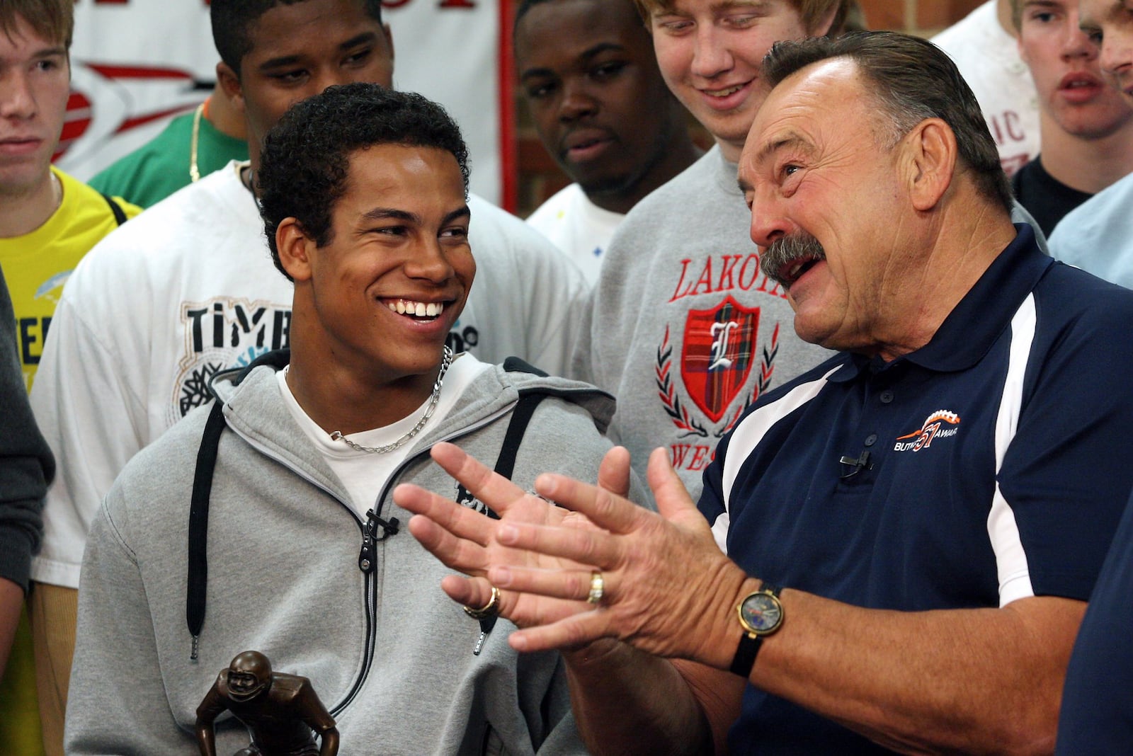 Lakota West High School senior Jordan Hicks talks with former Chicago Bears linebacker Dick Butkus after receiving the Dick Butkus Award for being the top prep linebacker in the country Dec. 9, 2009, at Lakota West. FILE PHOTO