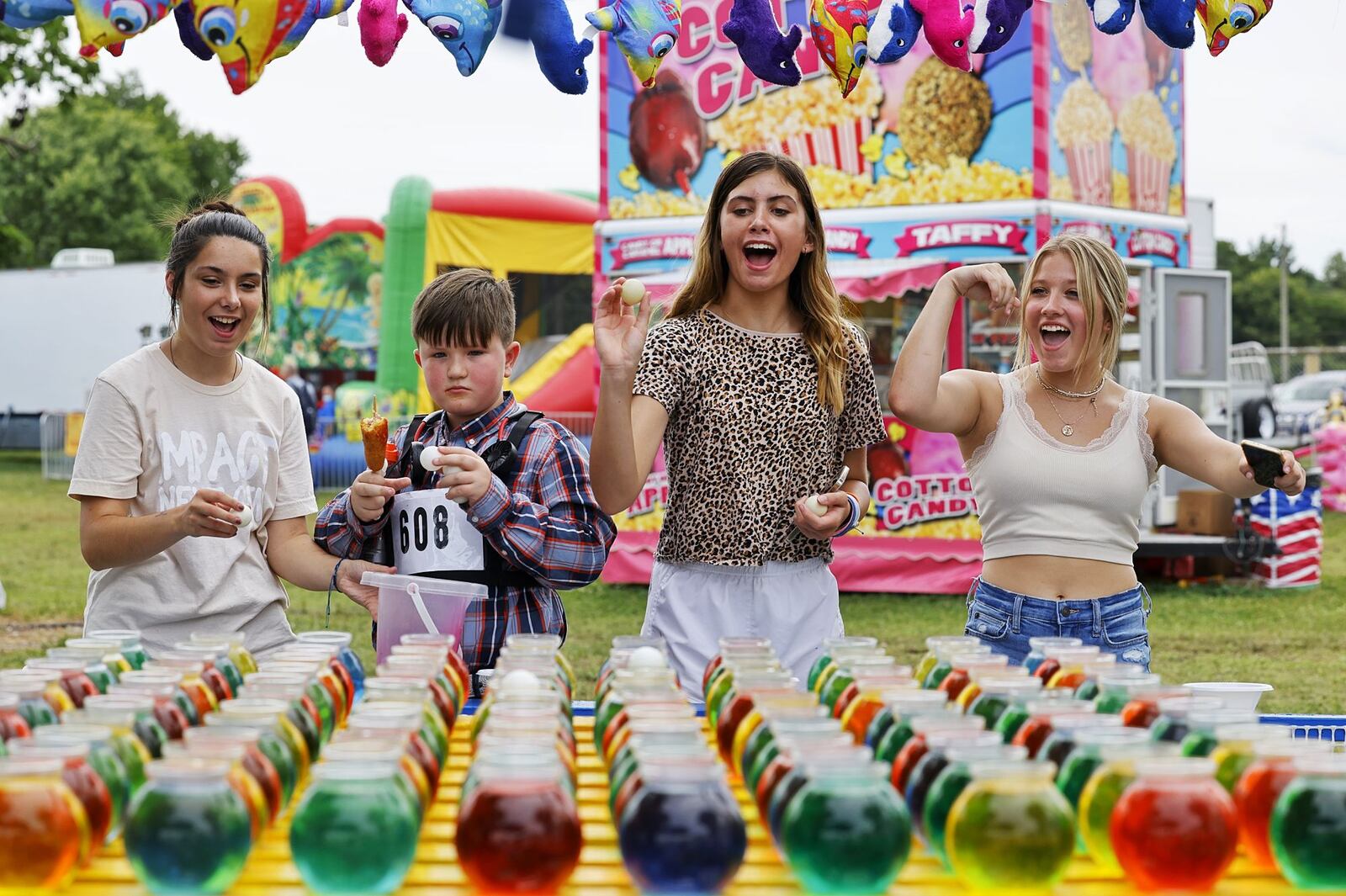 Left to right: Megan Otis, 15, Levon Robertson, 9, Alaina Morris, 13, and Lauren Counts, 14, celebrate winning goldfish at the Butler County Fair Monday, July 25, 2022 in Hamilton. NICK GRAHAM/STAFF