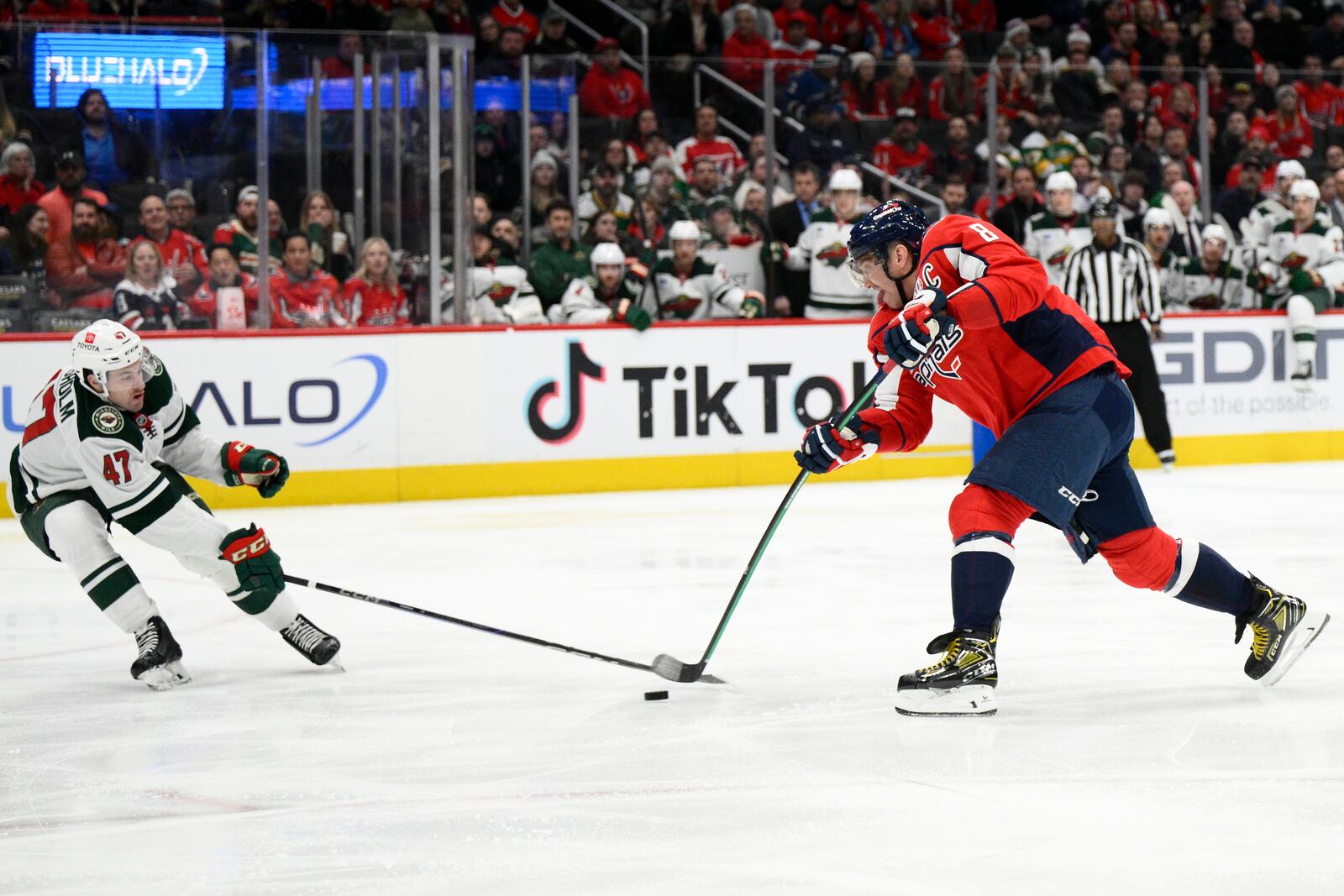 Washington Capitals left wing Alex Ovechkin (8) shoots the puck as Minnesota Wild defenseman Declan Chisholm (47) defends during the first period of an NHL hockey game, Thursday, Jan. 2, 2025, in Washington. (AP Photo/Nick Wass)