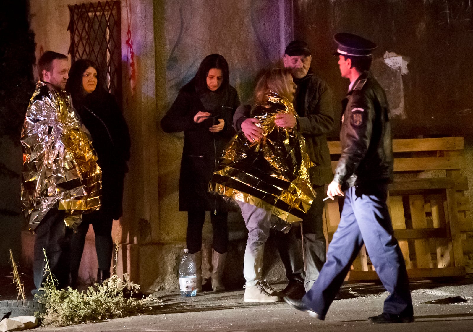 FILE - A survivor of a fire that occurred in a club in Bucharest, Romania, cries, wrapped in a thermal blanket outside the scene early Saturday, Oct. 31, 2015. (AP Photo/Vadim Ghirda, File)