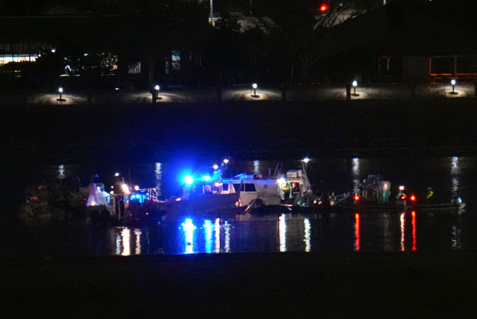 Rescuer workers respond to the scene on the Potomac River near Ronald Reagan Washington National Airport, Thursday, Jan. 30, 2025, in Arlington, Va. (AP Photo/Julio Cortez)