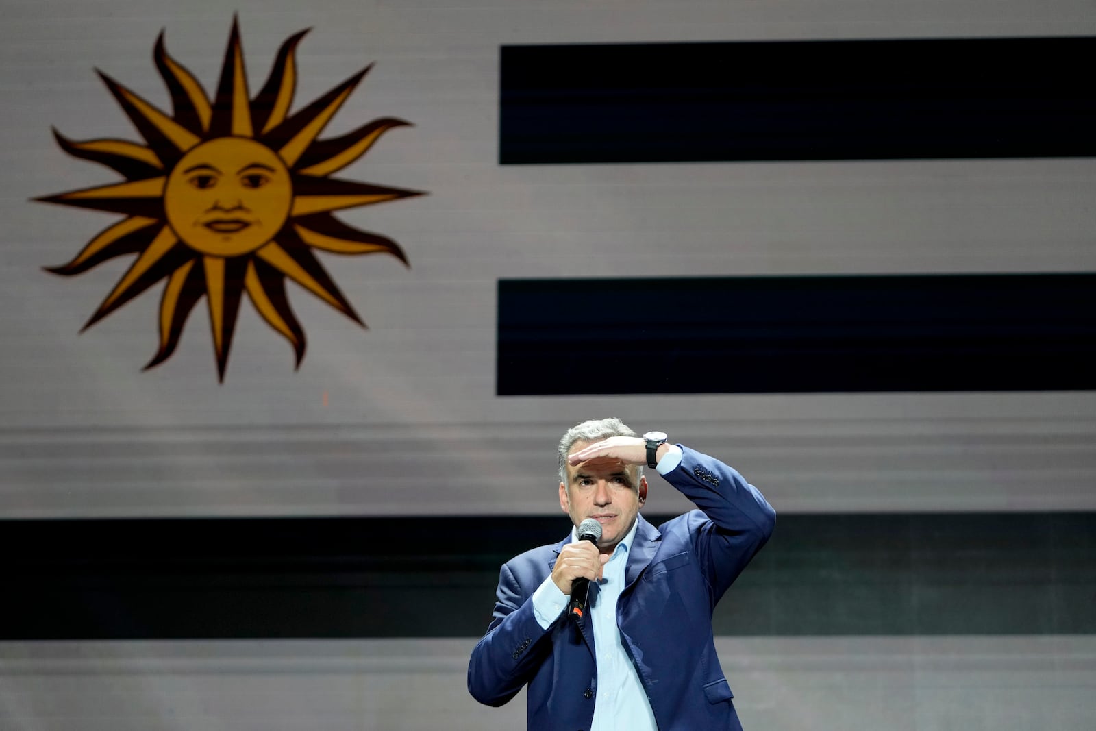 Frente Amplio presidential candidate Yamandu Orsi talks to supporters outside of a hotel after the general elections polls closed in Montevideo, Uruguay, Sunday, Oct. 27, 2024. (AP Photo/Natacha Pisarenko)