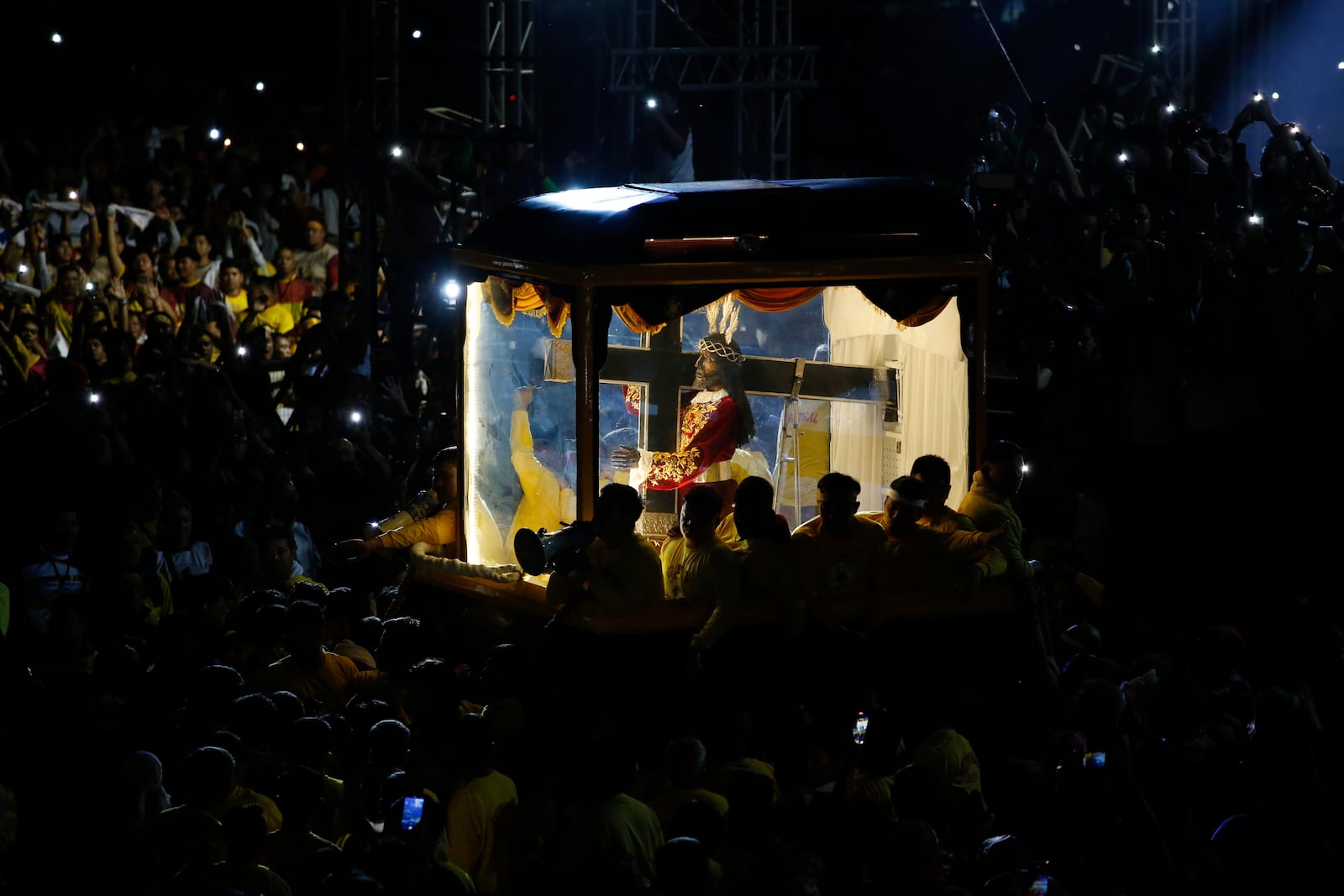 Devotees pull a glass-covered carriage carrying the image of Jesus Nazareno during its annual procession in Manila, Philippines, Thursday. Jan. 9, 2025. (AP Photo/Basilio Sepe)