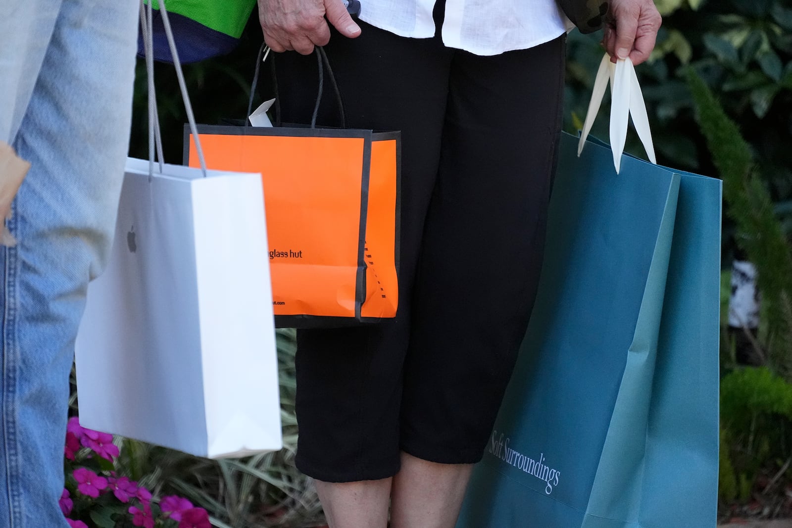 FILE - Shoppers hold bags after shopping in Bradenton, Fla., Feb. 9, 2024. (AP Photo/Gene J. Puskar. File)