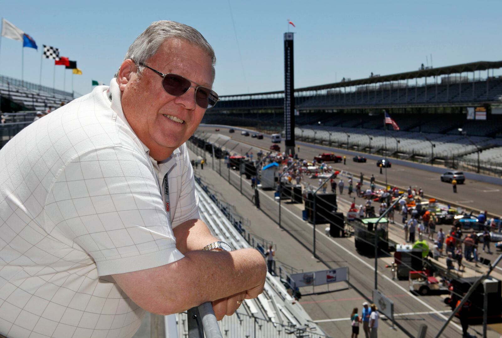 FILE - Associated Press auto racing writer Mike Harris poses along the main straightway at the Indianapolis Motor Speedway in Indianapolis, on Wednesday, May 20, 2009. (AP Photo/Michael Conroy, File)