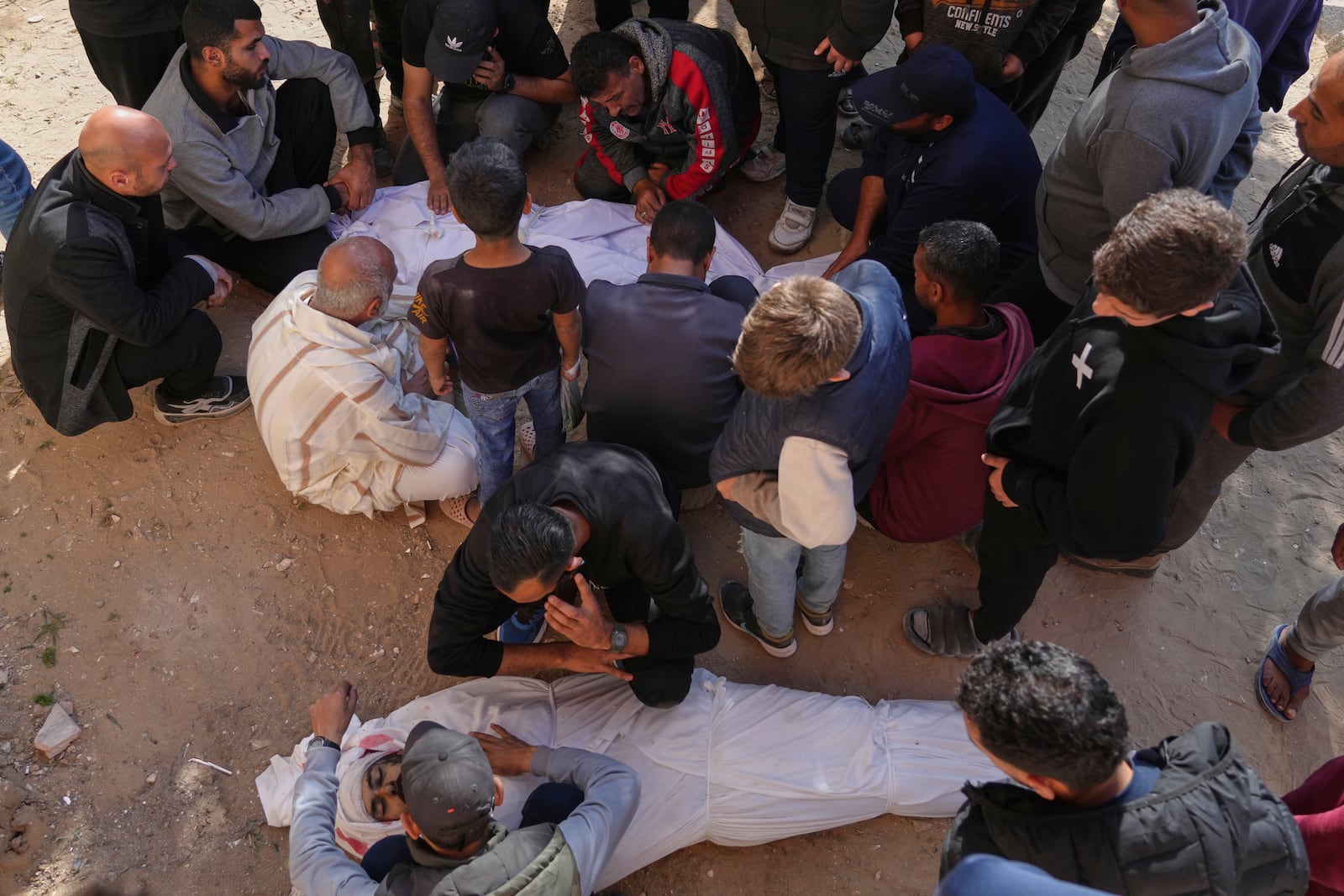 Palestinians mourn over the bodies of their relatives killed by an Israeli airstrike in Beit Lahiya, northern Gaza Strip on Saturday, March 15, 2025. (AP Photo/Jehad Alshrafi)