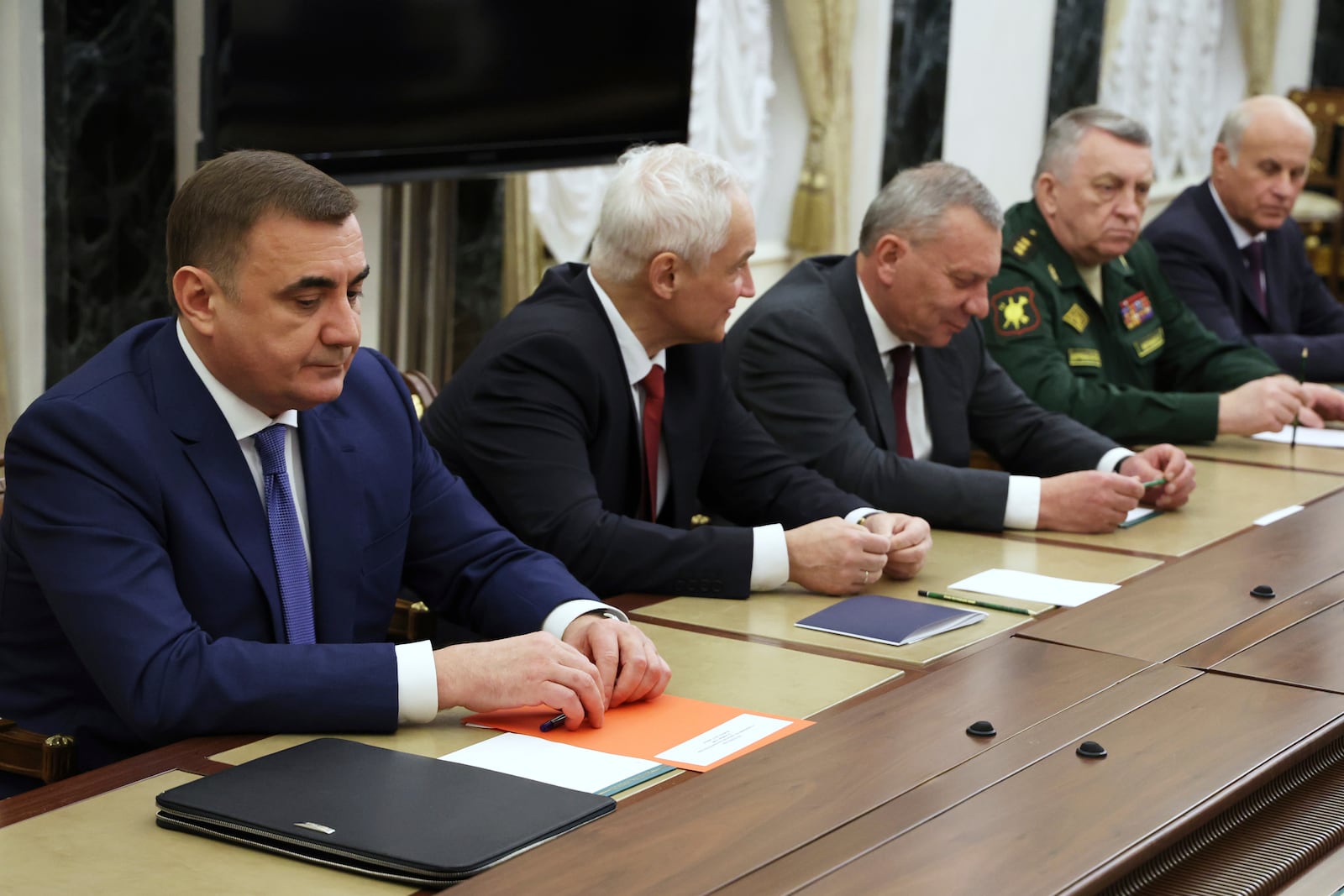 Russian Presidential Aide Aleksei Dyumin, left, Russian Defense Minister Andrei Belousov, second left, the head of Russian state space corporation Roscosmos Yuri Borisov, third right, and other wait for the meeting of Russian President Vladimir Putin and the leadership of the Russian Ministry of Defense, representatives of the military-industrial complex and developers of missile systems at the Kremlin in Moscow, Russia, Friday, Nov. 22, 2024. (Vyacheslav Prokofyev, Sputnik, Kremlin Pool Photo via AP)