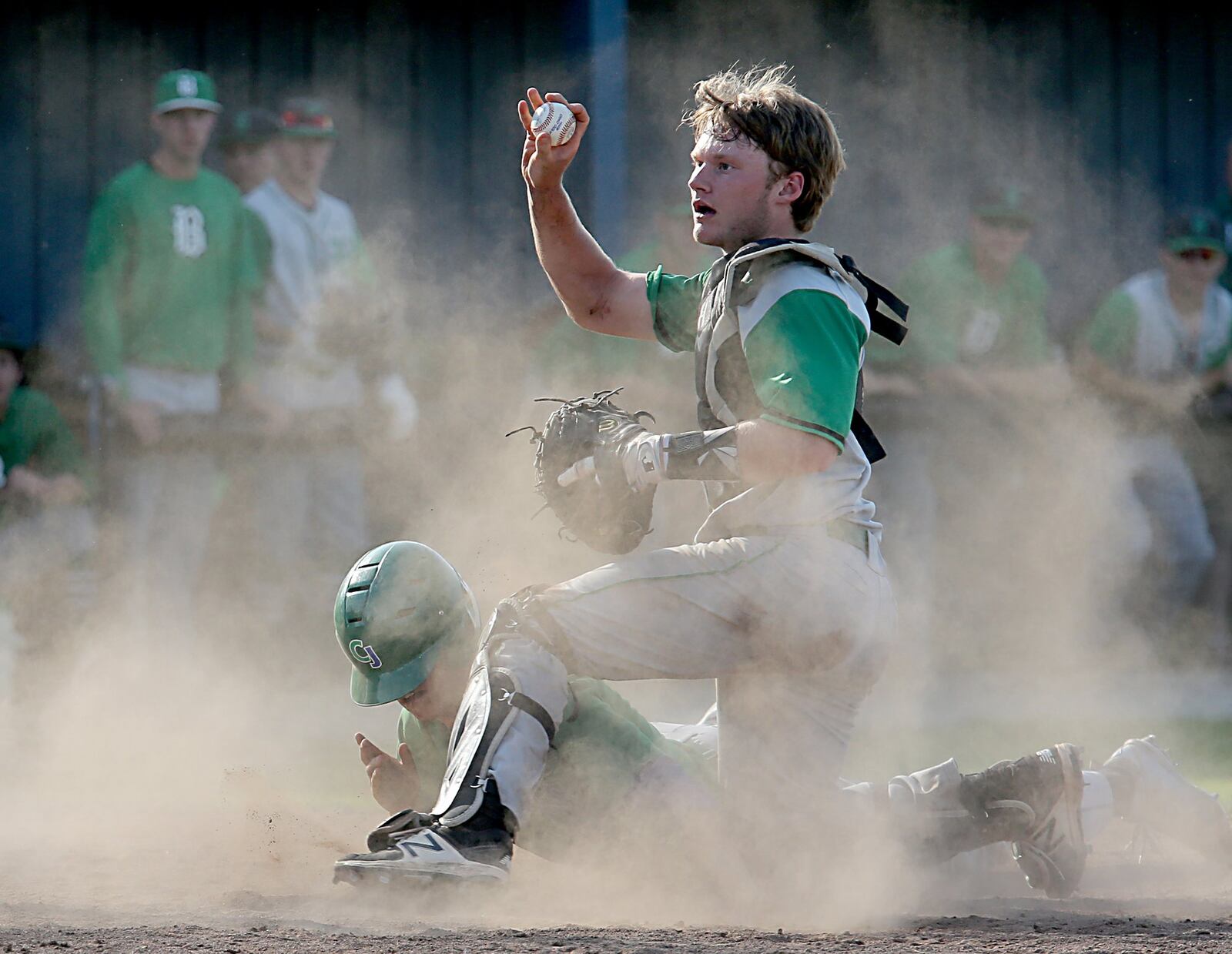 Badin catcher Zac Wilson shows the home-plate umpire the ball as Chaminade Julienne’s Cameron Benoit covers home plate and scores the game-winning run Thursday during a Division II sectional final at Miamisburg. CONTRIBUTED PHOTO BY E.L. HUBBARD