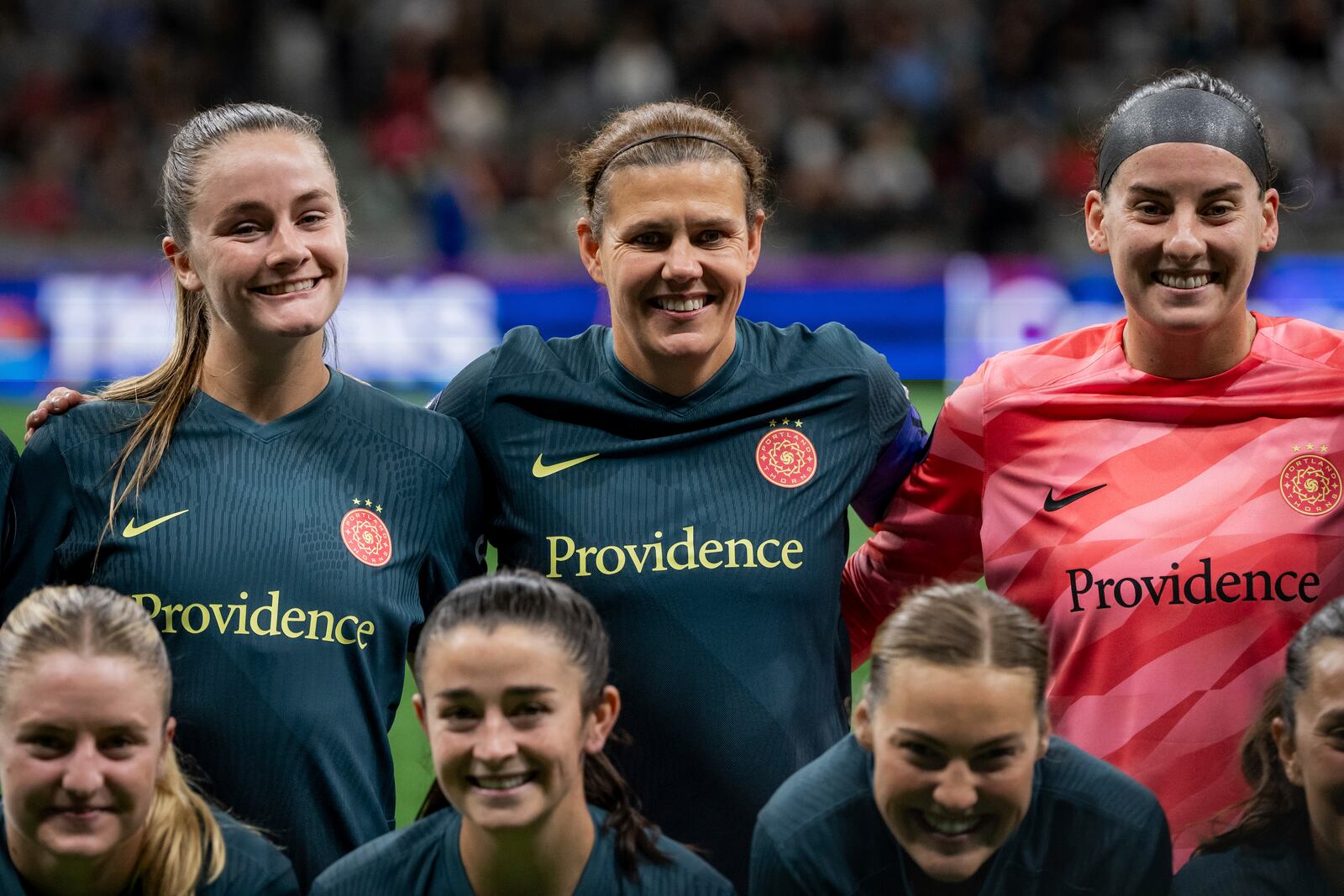 Portland Thorns FC's Christine Sinclair, center, lines up for a starting lineup photo with her teammates, before a CONCACAF W Champions Cup soccer match against the Vancouver Whitecaps in Vancouver, British Columbia on Tuesday, Oct. 15, 2024. (Ethan Cairns/The Canadian Press via AP)