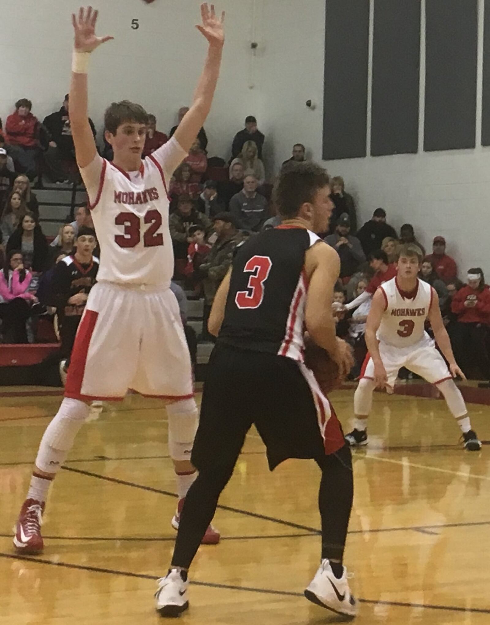 Madison’s Grant Whisman (32) and Mason Whiteman keep an eye on Preble Shawnee’s Tyler Worley during Saturday night’s game in Madison Township. RICK CASSANO/STAFF