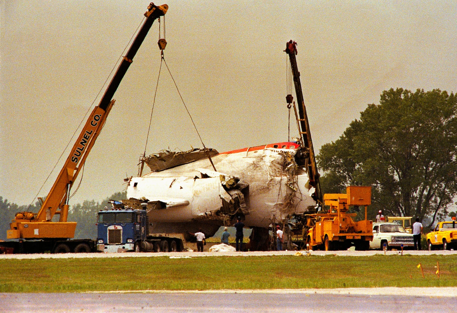 FILE - In this July 22, 1989 file photo cranes lift the tail section of United Airlines Flight 232 onto a truck after the McDonnell Douglas DC-10 carrying nearly 300 people crash landed at the Sioux City, Iowa, airport. (AP Photo/James Finley, File)