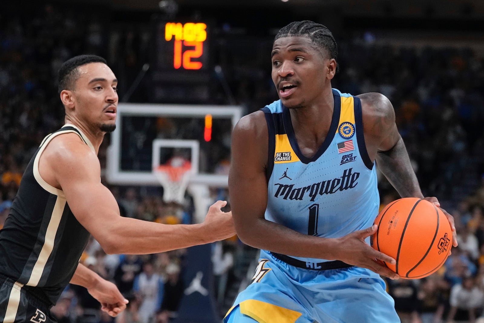 Marquette's Kam Jones tries to get past Purdue's Trey Kaufman-Renn during the first half of an NCAA college basketball game Tuesday, Nov. 19, 2024, in Milwaukee. (AP Photo/Morry Gash)