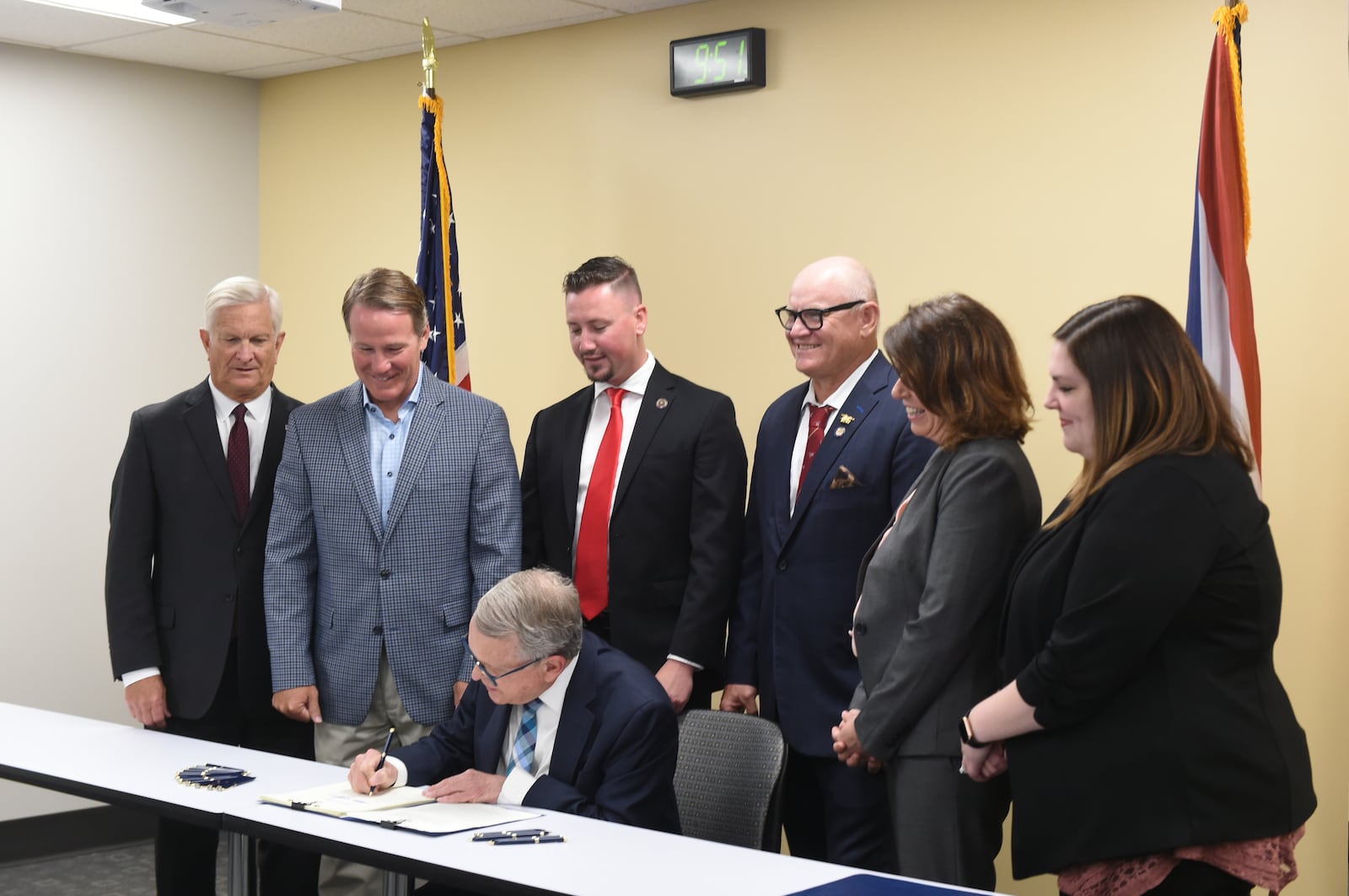 State Rep. Thomas Hall of Madison Twp. (red tie, behind Governor Mike DeWine) spearheaded a school gun and safety training bill that was signed into law by DeWine on June 13, 2022. CONTRIBUTED