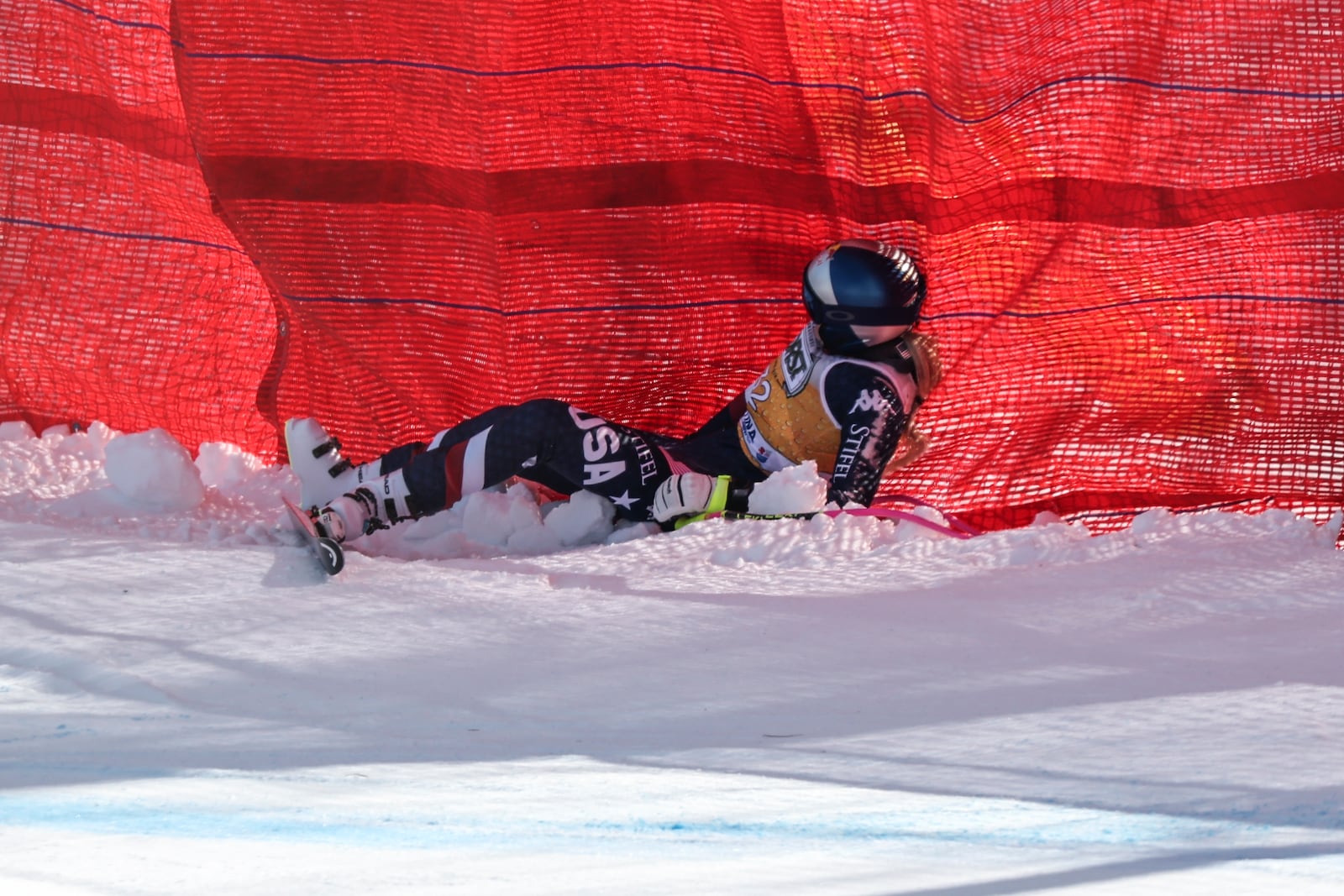 United States' Lindsey Vonn lies on the snow after crashing during an alpine ski, women's World Cup downhill training, in Cortina d'Ampezzo, Italy, Thursday, Jan. 16, 2025. (AP Photo/Marco Trovati)