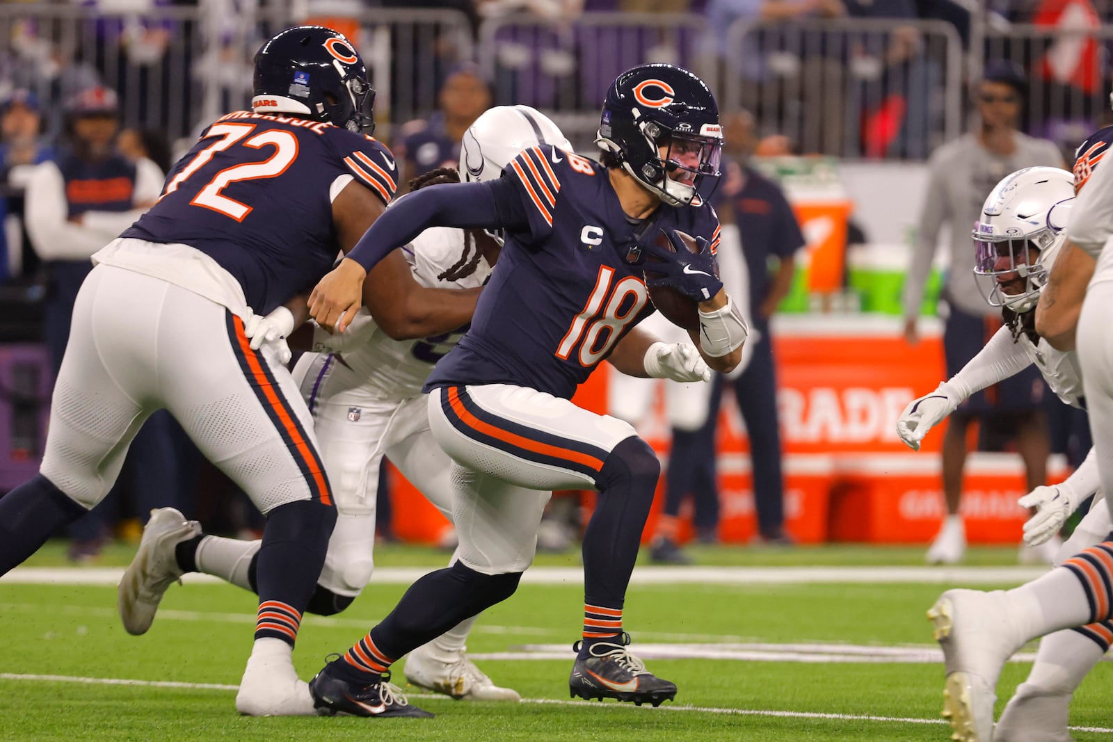 Chicago Bears quarterback Caleb Williams (18) runs up field during the first half of an NFL football game against the Minnesota Vikings, Monday, Dec. 16, 2024, in Minneapolis. (AP Photo/Bruce Kluckhohn)