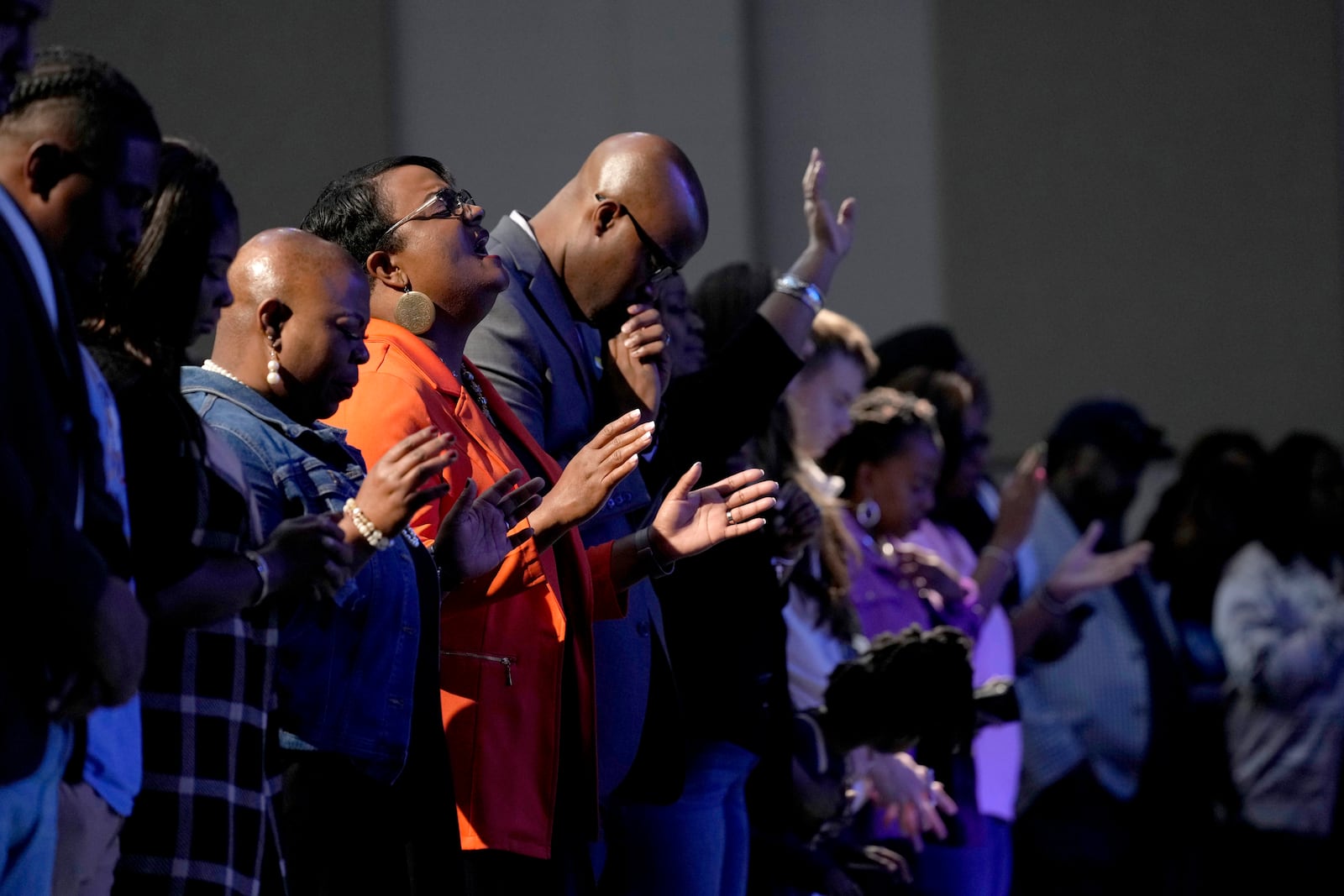 Attendees pray before Democratic presidential nominee Vice President Kamala Harris arrives to speak during a church service at Koinonia Christian Center in Greenville, N.C., Sunday, Oct. 13, 2024. (AP Photo/Susan Walsh)