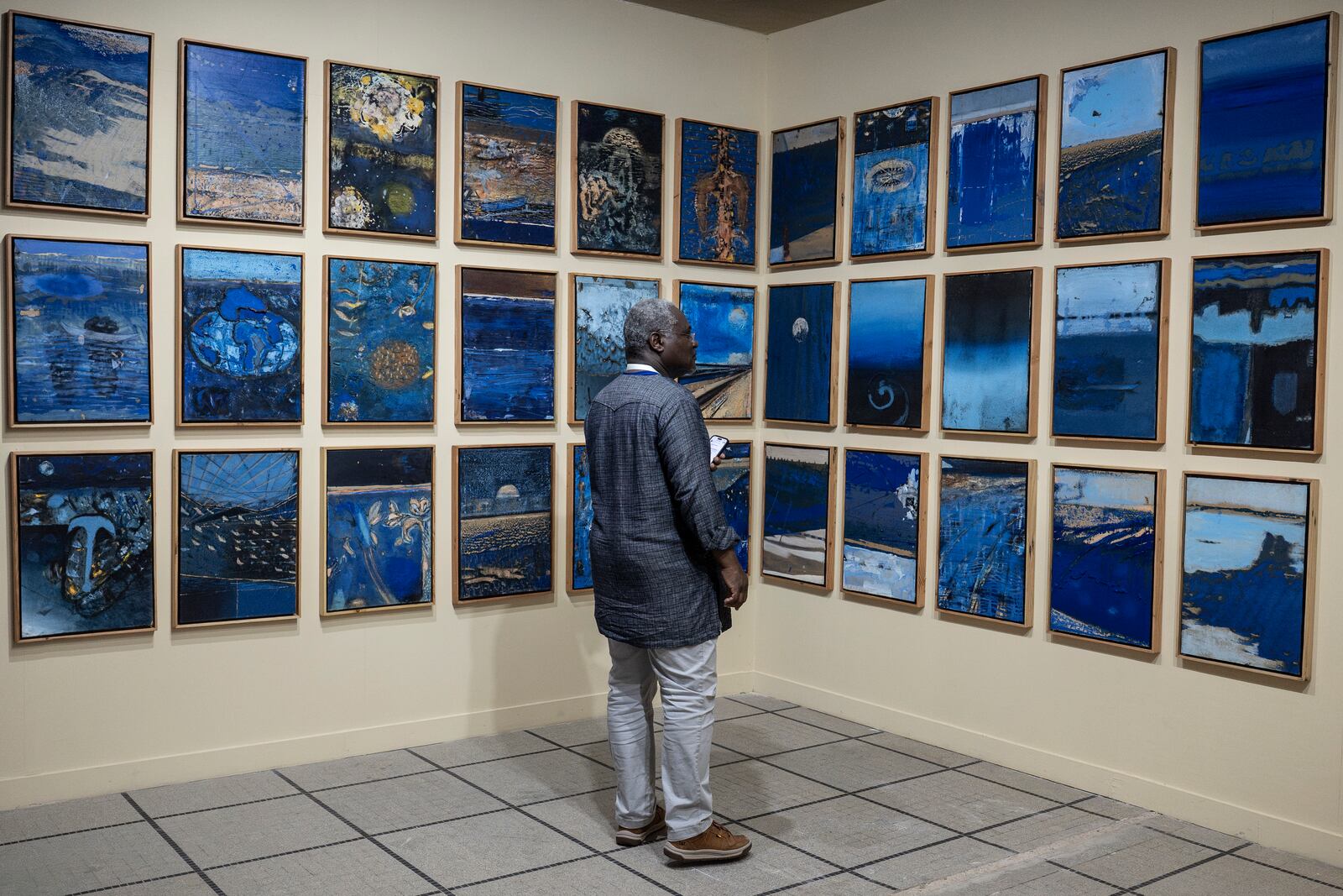 A visitor explores the international exhibit at the Dakar Biennale of Contemporary African Art in Dakar, Senegal, Friday, Nov. 8, 2024. (AP Photo/Annika Hammerschlag)