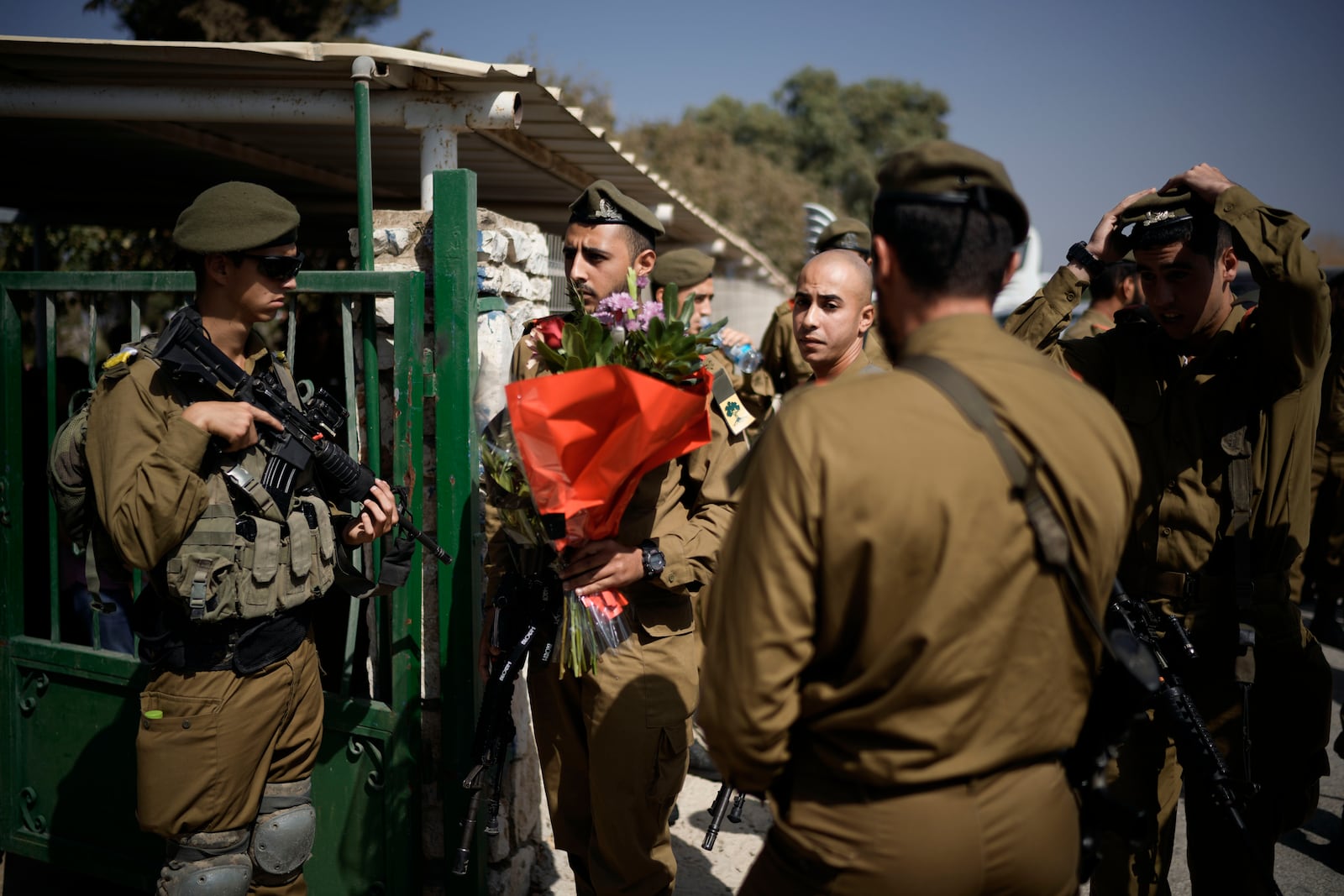 Israeli soldiers mourn Sgt. Yosef Hieb, killed Sunday by a Hezbollah drone attack that wounded dozens and killed four soldiers, while at his funeral in Tuba Zangariyye, Israel, Monday, Oct. 14, 2024. (AP Photo/Leo Correa)