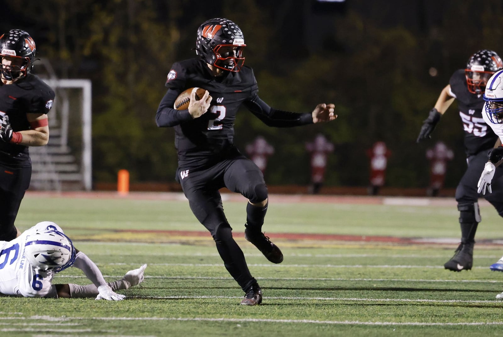 Lakota West quarterback Sam Wiles runs the ball during their Division 1 playoff football game against St. Xavier Friday, Nov. 15, 2024 at Princeton's Mancuso Field in Sharonville. St. Xavier won 16-13 to advance. NICK GRAHAM