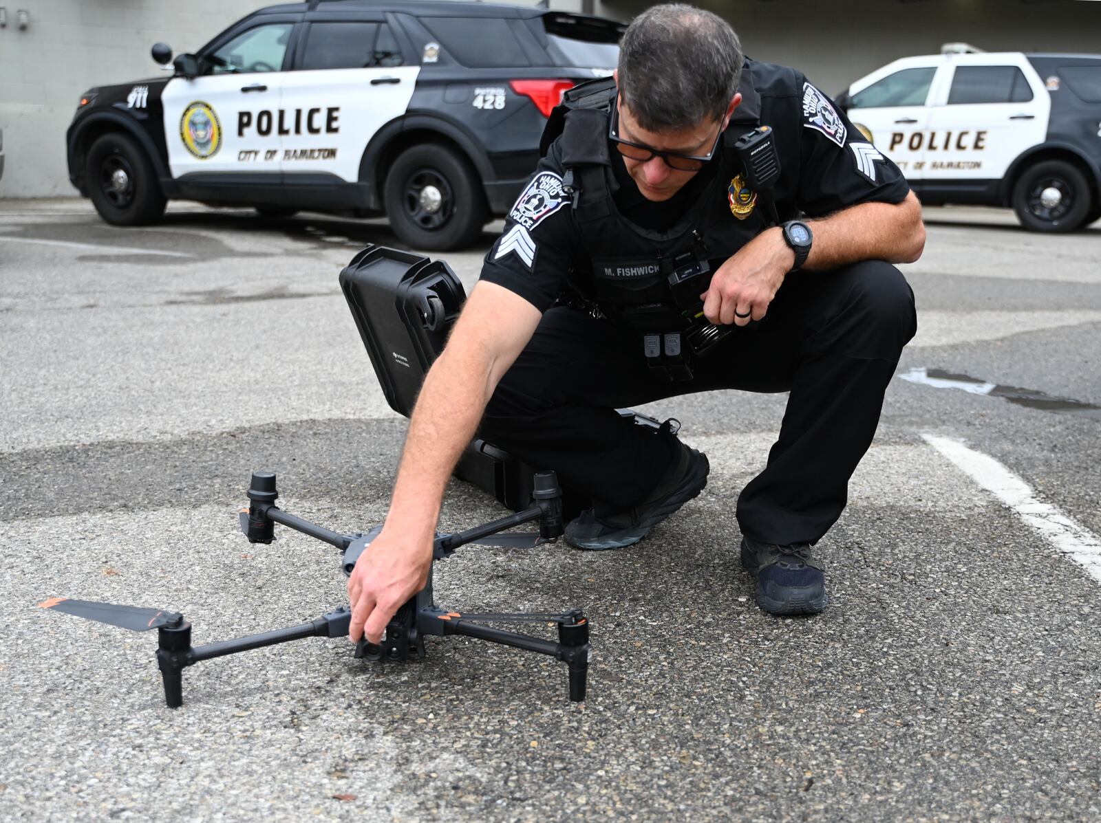 Hamilton Police Sgt. Matt Fishwick sets up a demonstration on Tuesday, Sept. 24, 2024, the HPD's patrol drone, which is used, among other things, for searches of missing people, searching for suspects, and observing traffic patterns. The department has had a drone for SWAT operations for several years, and was one of the last departments in Butler County to acquire a drone for patrol purposes. MICHAEL D. PITMAN/STAFF