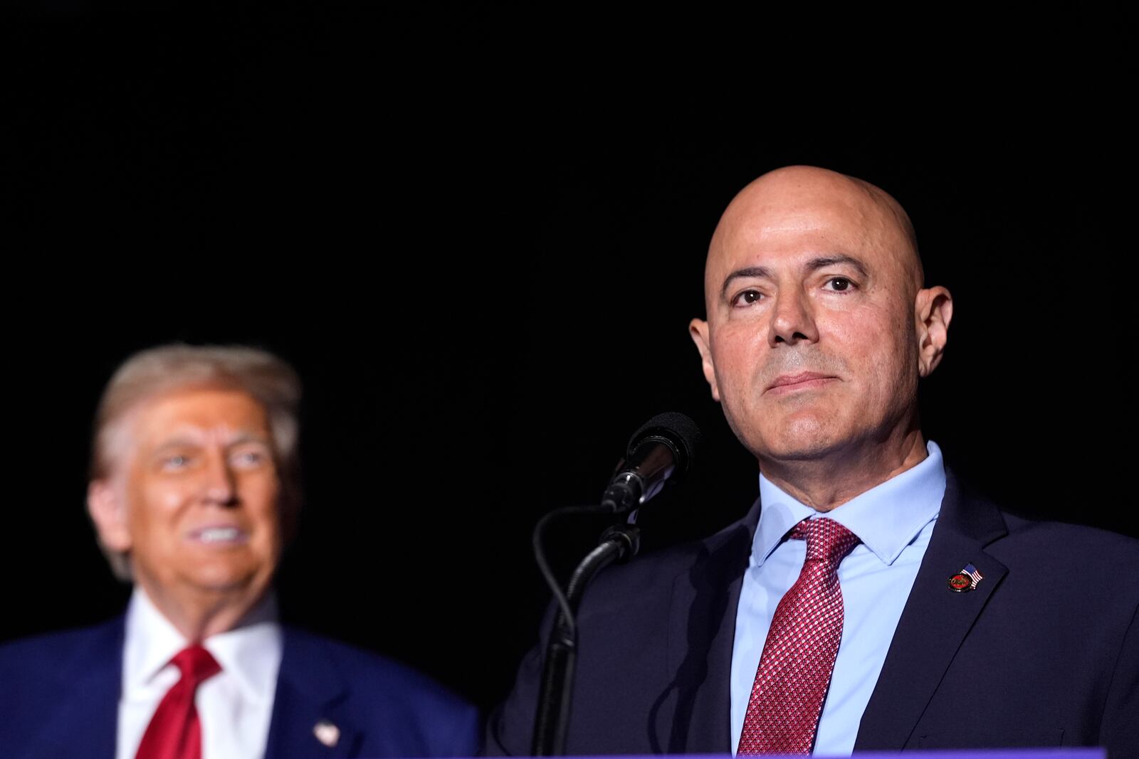 Dearborn Heights, Mich. Mayor Bill Bazzi speaks as Republican presidential nominee former President Donald Trump looks on during a campaign rally at the Suburban Collection Showplace, Saturday, Oct. 26, 2024, in Novi, Mich. (AP Photo/Alex Brandon)