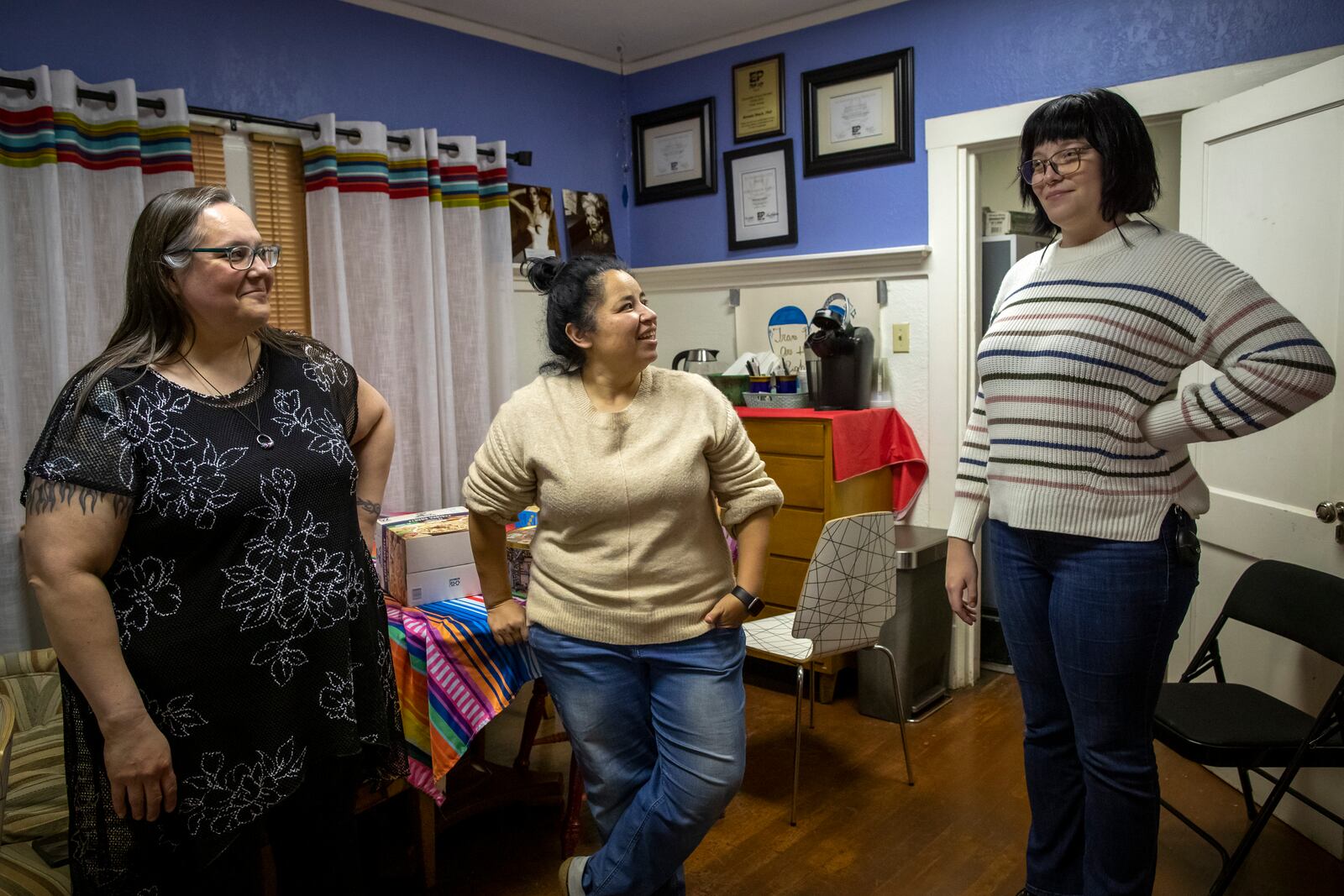 Emiliana Edwards, right, former patient of pediatric endocrinologist Dr. Hector Granados chats with her mother Lorena Edwards, left, and Amber Perez, executive director of the Borderland Rainbow Center, in El Paso, Texas, Tuesday, Jan. 21, 2025. (AP Photo/Andres Leighton)