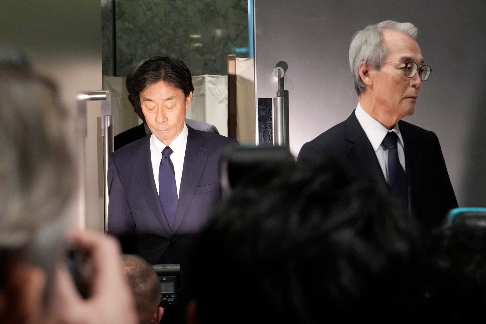 From left, Koichi Minato, President and CEO of Fuji Television Network, and Shuji Kano, Fuji Media Holdings COB, arrive for a press conference at Fuji Television headquarter in Tokyo, Monday, Jan. 27, 2025. (AP Photo/Eugene Hoshiko)