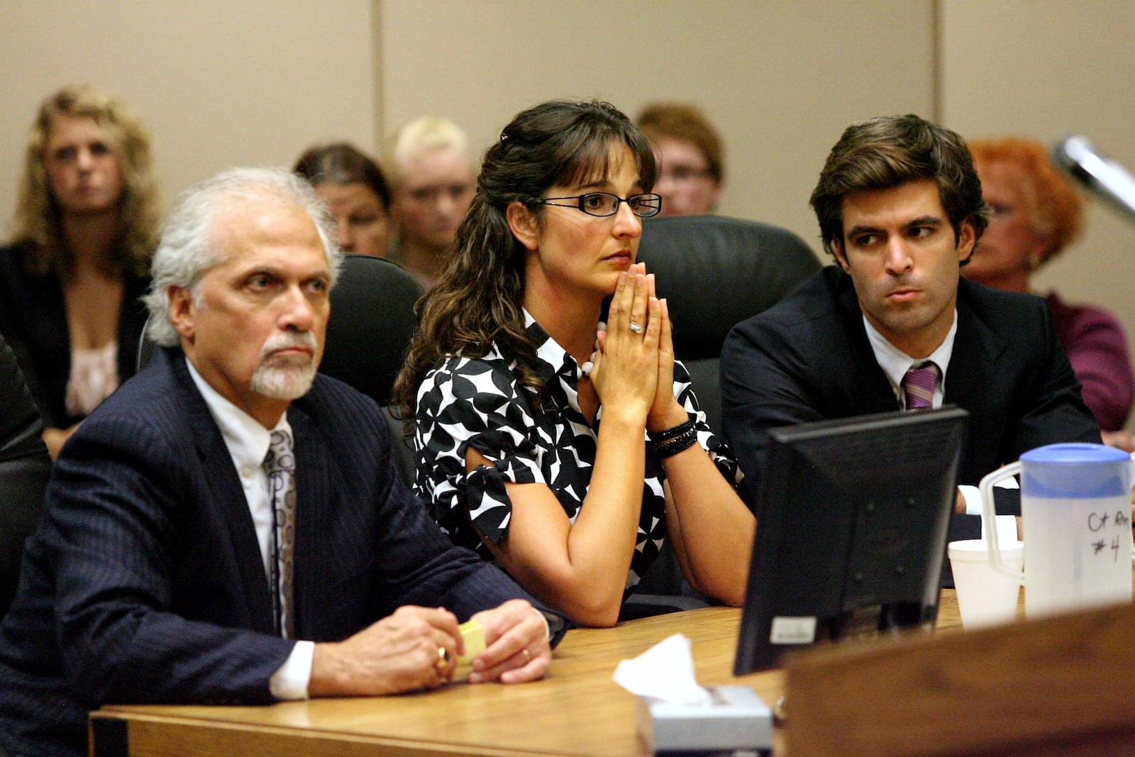 Stacy Schuler sits between her lawyers Charlie Rittgers (left) and Charlie M. Rittgers during her fourth day of trial in Warren County Common Pleas Court Thursday, Oct. 27, 2011. Schuler, 33, was sentenced to four years in prison after being found guilty on all 16 felony counts of sexual battery and three misdemeanor counts of providing alcohol to minors.