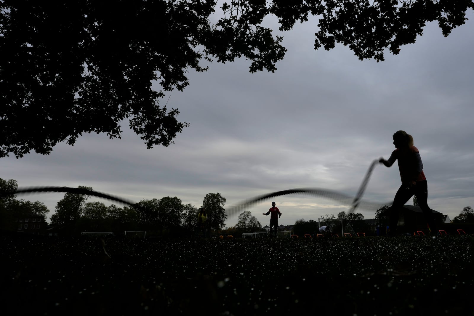 A participant takes part in an outdoor gym class led by personal fitness trainer Richard Lamb in London, Saturday, Oct. 26, 2024, Lamb works for Alan Ezen, and his company Zen Training. (AP Photo/Alastair Grant)