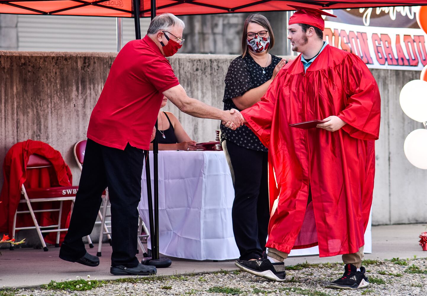 Madison High School drive-thru graduation ceremony at Land of Illusion