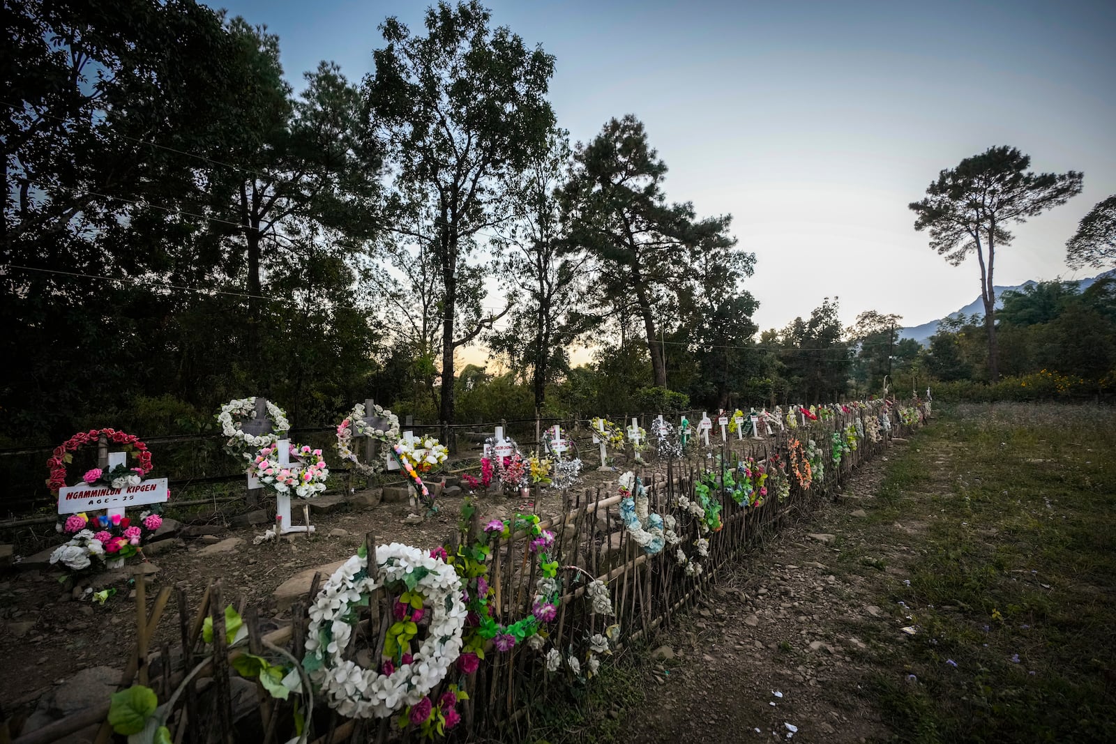 Flowers are placed at a burial ground of Kuki victims died during Kuki and Meitei clashes in Kangpokpi, Manipur, Sunday, Dec. 15, 2024. (AP Photo/Anupam Nath)