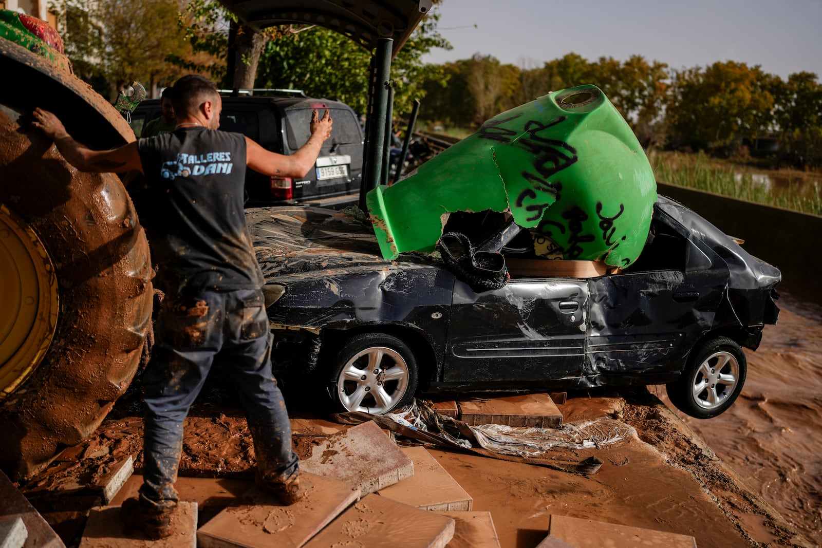 Flooded cars are piled up in Utiel, Spain, Wednesday, Oct. 30, 2024. (AP Photo/Manu Fernandez)