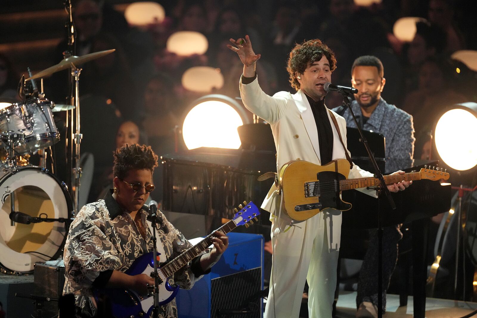 Brittany Howard, from left, Tony Goldsmith, and John Legend perform "I Love L.A." during the 67th annual Grammy Awards on Sunday, Feb. 2, 2025, in Los Angeles. (AP Photo/Chris Pizzello)