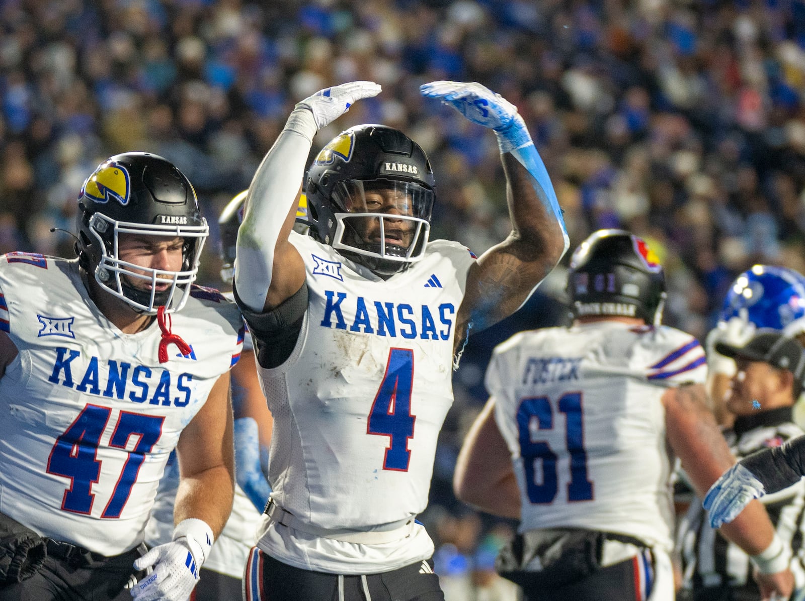 Kansas running back Devin Neal (4) celebrates his touchdown with Kansas cornerback Jacoby Davis during the first half of an NCAA college football game against BYU, Saturday, Nov. 16, 2024, in Provo. (AP Photo/Rick Egan)