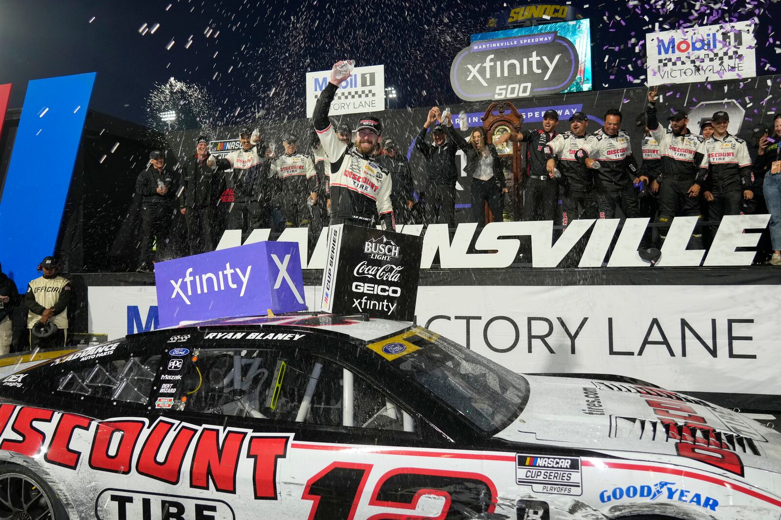 Ryan Blaney, center, celebrates in Victory Lane after winning a NASCAR Cup Series auto race at Martinsville Speedway in Martinsville, Va., Sunday, Nov. 3, 2024. (AP Photo/Chuck Burton)