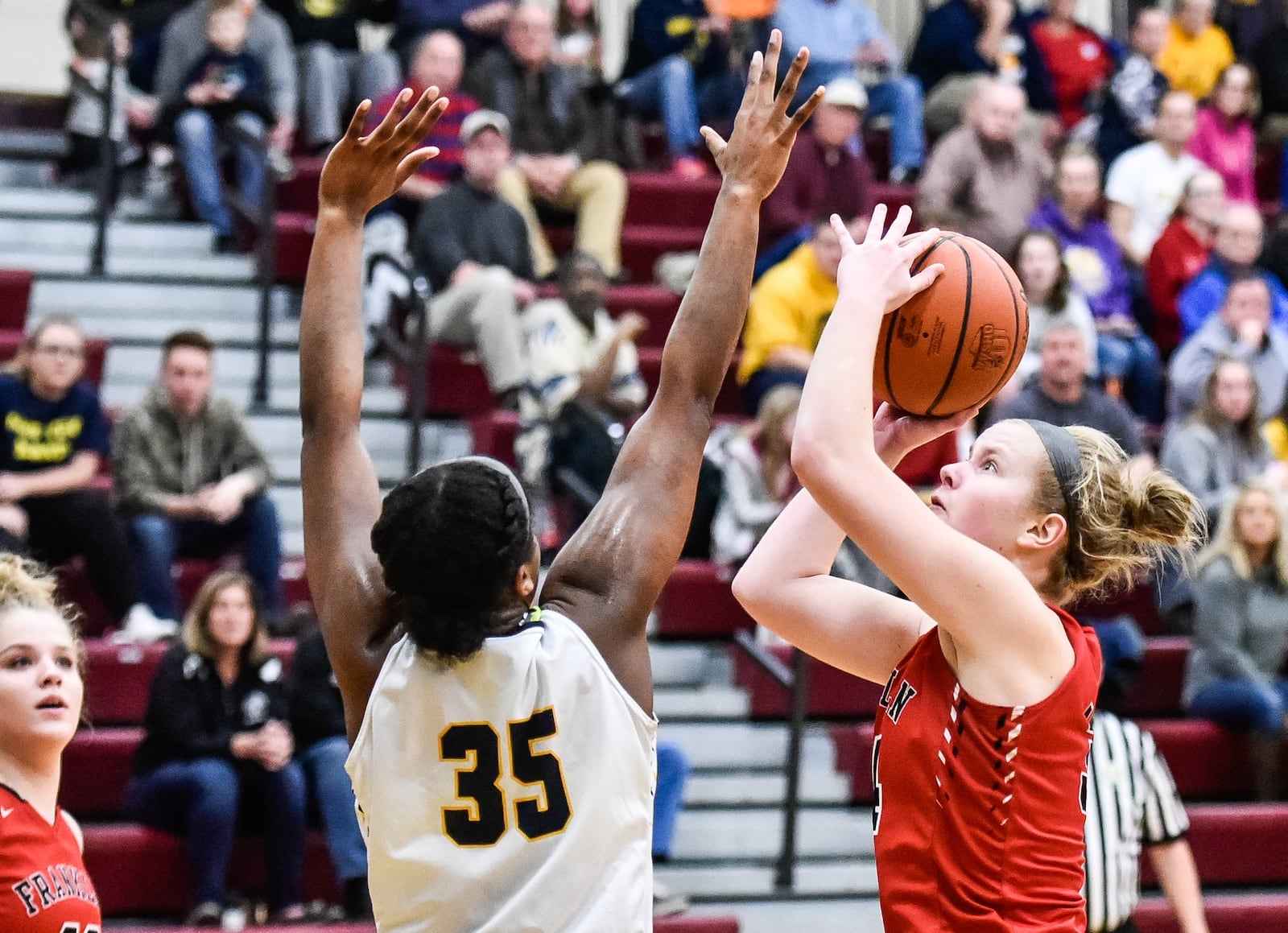 Franklin’s Brooke Stover puts up a shot over Monroe’s Olivia Wells-Daniels during Monday night’s Division II sectional final at Lebanon. NICK GRAHAM/STAFF