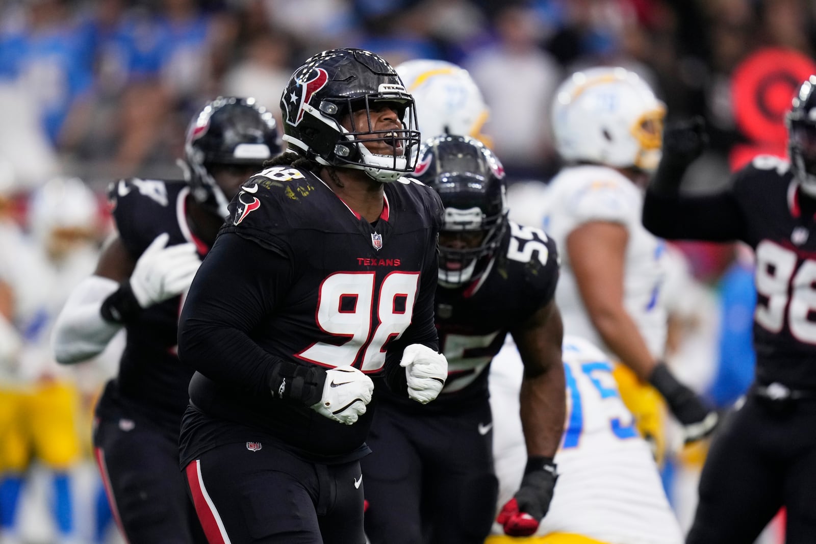 Houston Texans' Tim Settle Jr. (98) celebrates after the Texans stopped the Los Angeles Chargers on third down during the first half of an NFL wild-card playoff football game Saturday, Jan. 11, 2025, in Houston. (AP Photo/Eric Christian Smith)