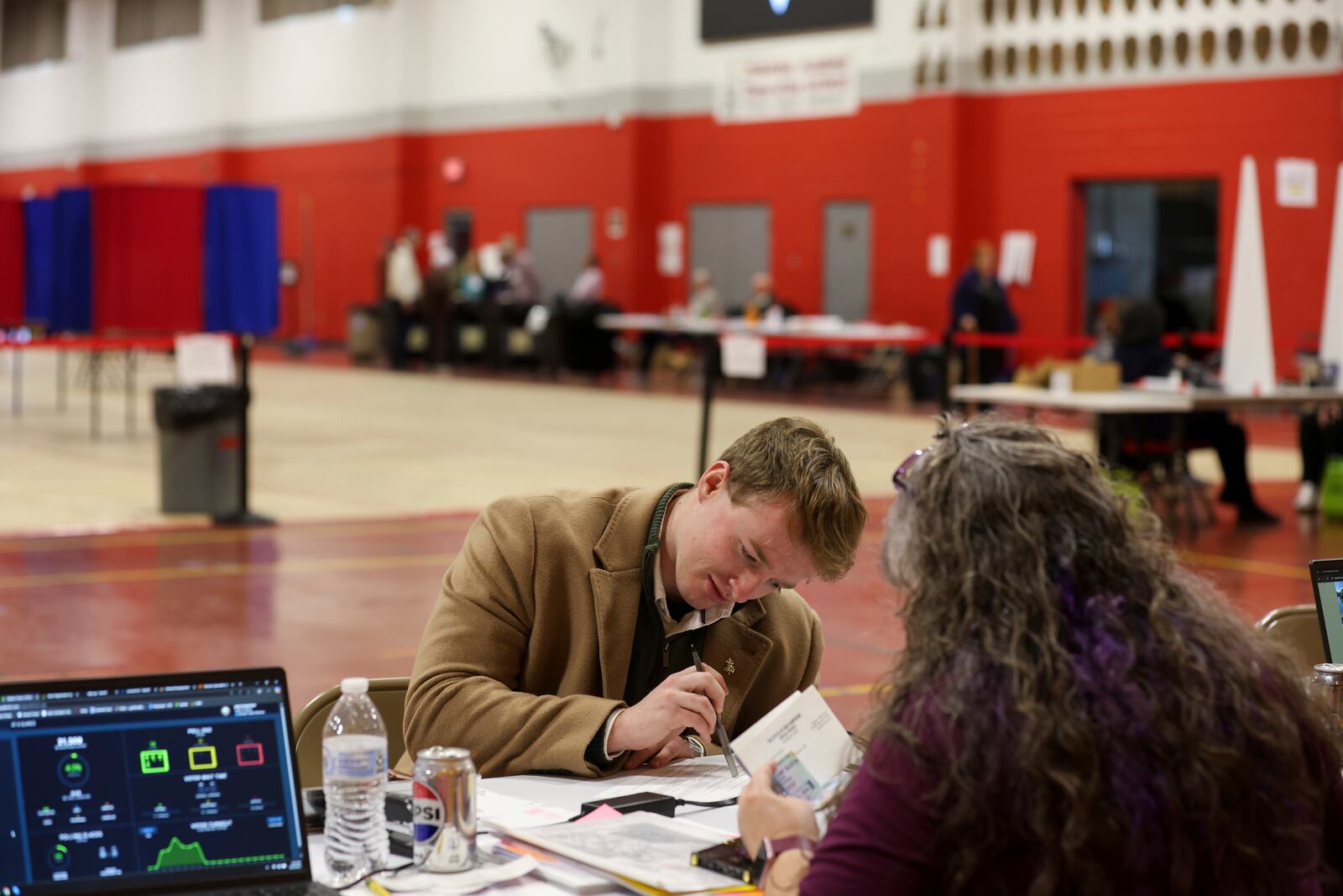 Michael Appleton registers to vote in Derry, N.H., Tuesday, March 11, 2025. (AP Photo/Reba Saldanha)