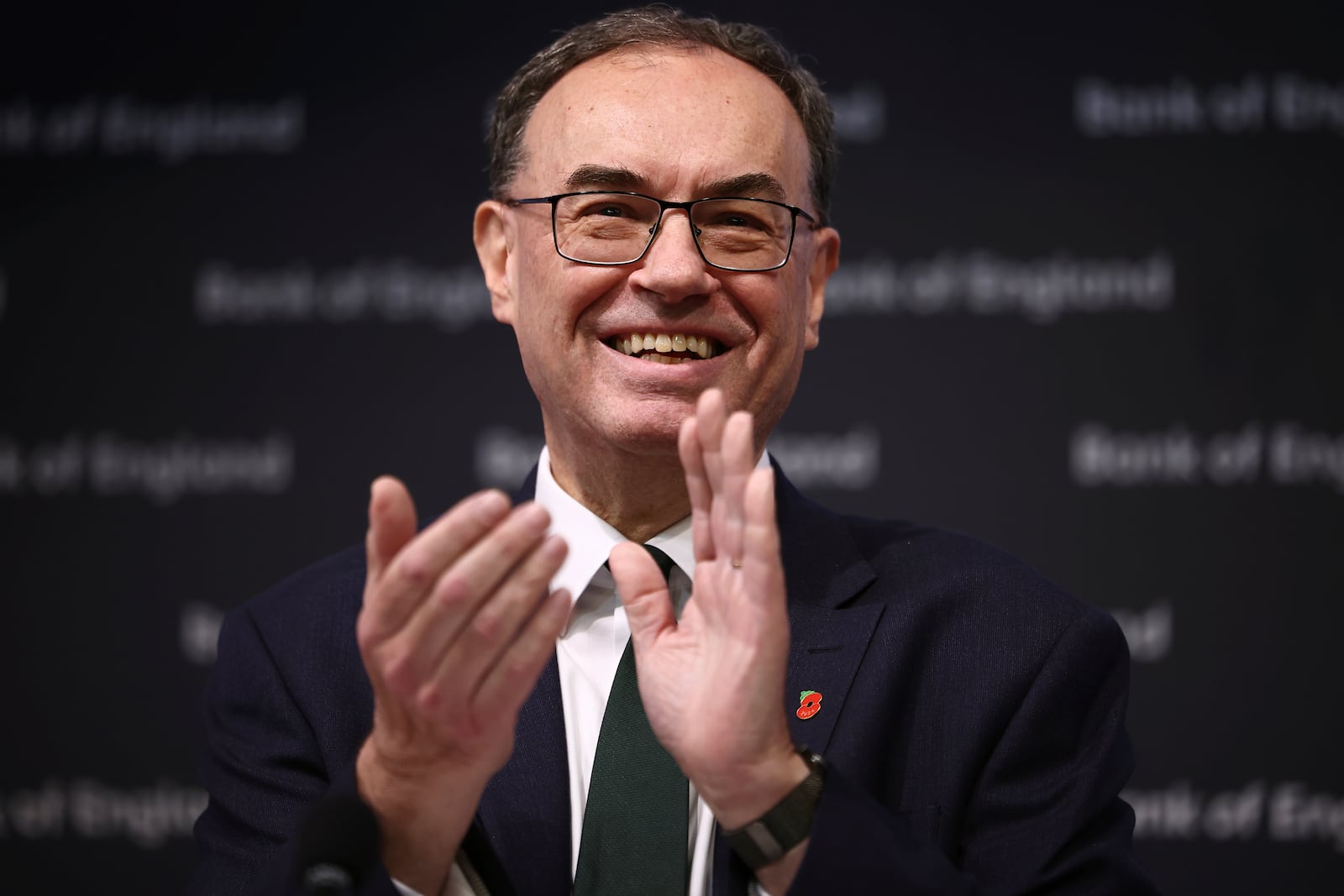 Bank of England Governor Andrew Bailey applauds during the central bank's Monetary Policy Report press conference at the Bank of England, in London, Thursday, Nov. 7, 2024. (Henry Nicholls/Pool Photo via AP)