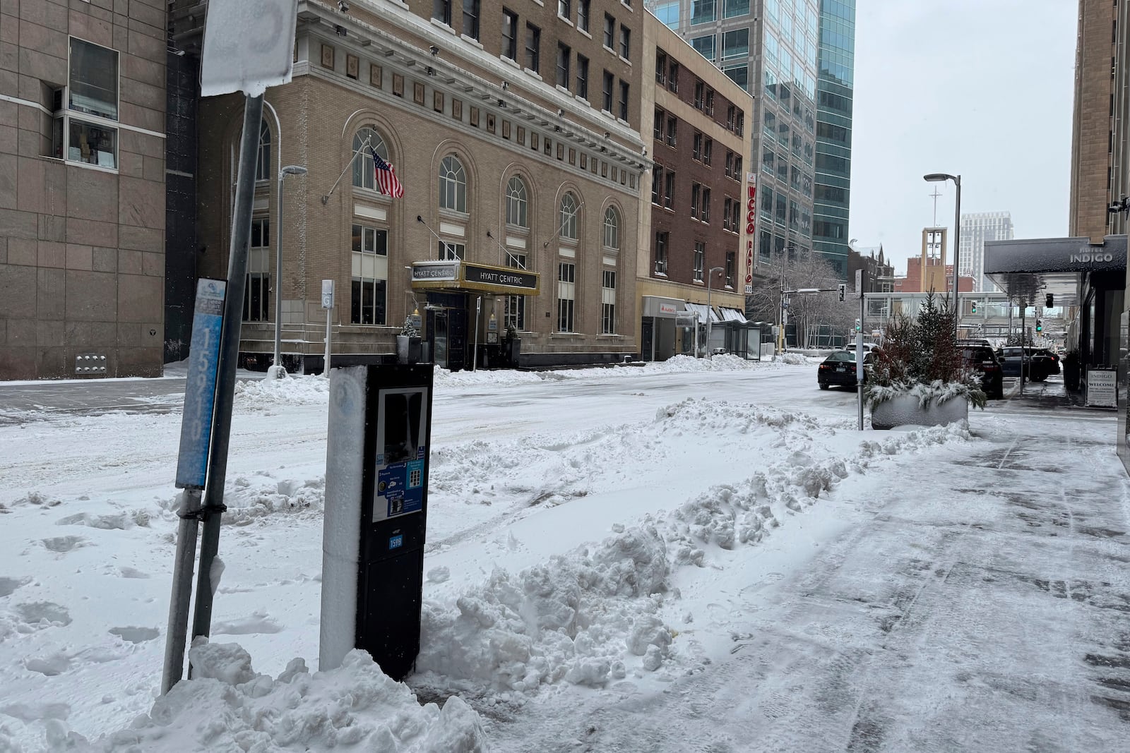 Snow continued to descend in downtown Minneapolis through the morning, Wednesday, March 5, 2025, leaving roads coated with slush and ice. (AP Photo/Sarah Raza)