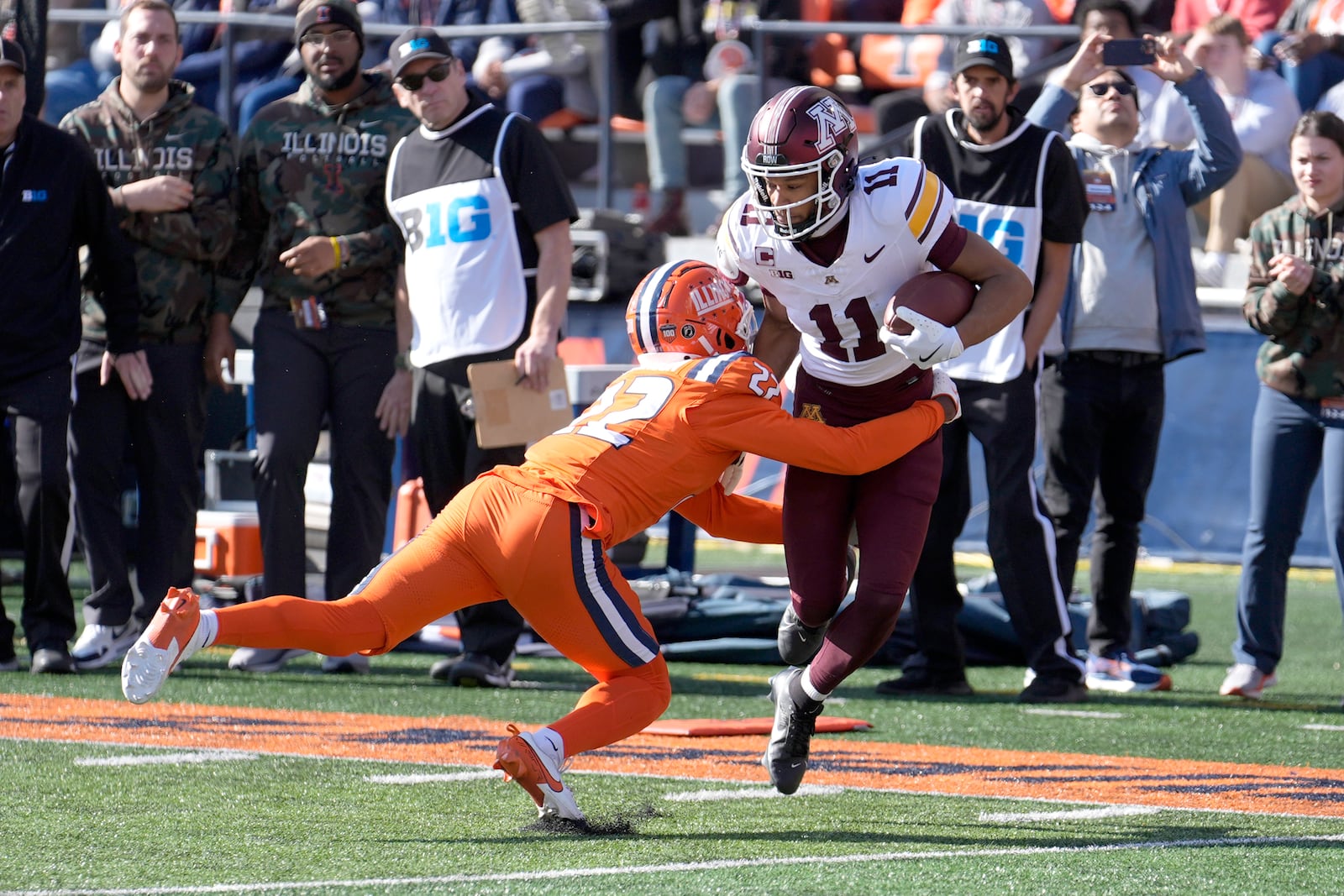 Minnesota wide receiver Elijah Spencer advances the ball off a pass reception as Illinois defensive back Kaleb Patterson makes the tackle during the first half of an NCAA college football game Saturday, Nov. 2, 2024, in Champaign, Ill. (AP Photo/Charles Rex Arbogast)