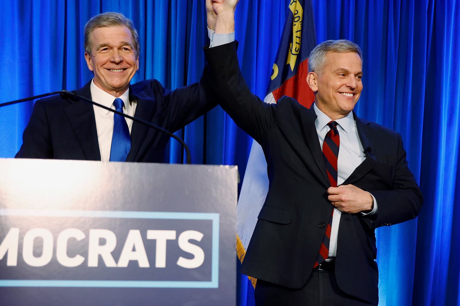 FILE - North Carolina's Democratic gubernatorial candidate Josh Stein, right, is introduced by North Carolina Gov. Roy Cooper at a primary election night party in Raleigh, N.C., March 5, 2024. (AP Photo/Karl B DeBlaker, File)